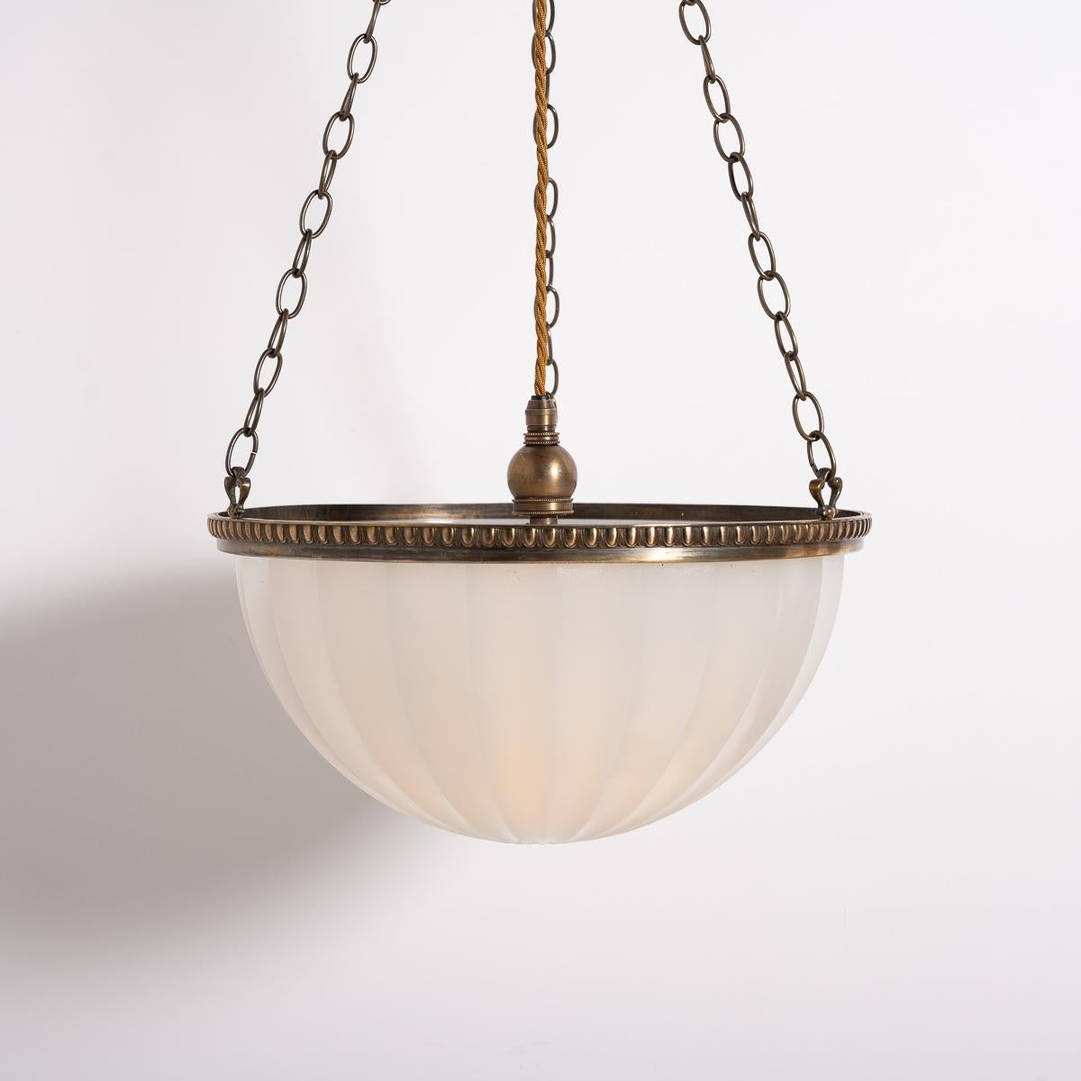Add classic elegance to your space with this rare matched pair of Jefferson moonstone plafonnier luminaires. The 14-inch diameter moonstone bowls produce a diffused light, and they are encased in their original brass mounts, designed to illuminate