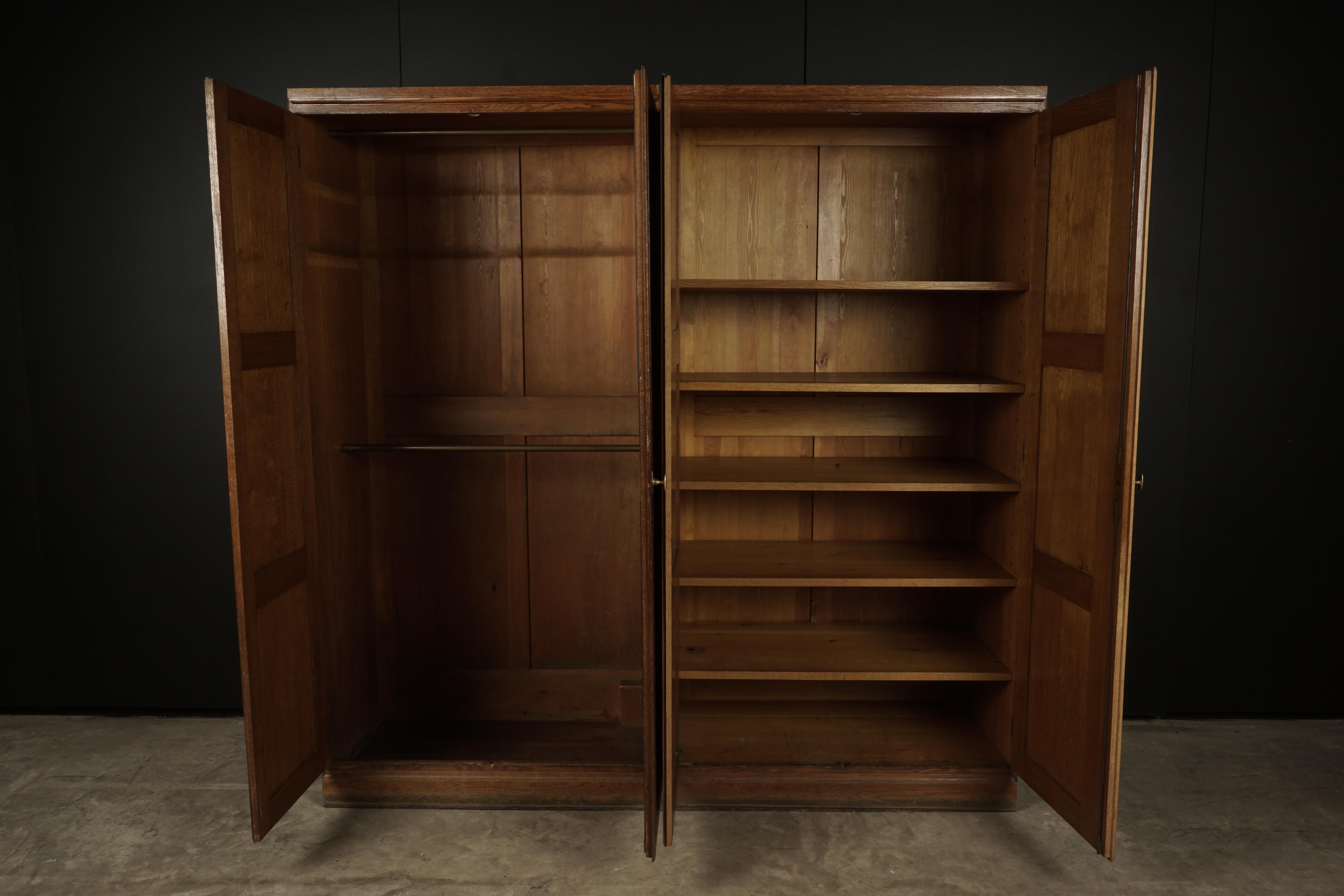 Rare pair of large oak wardrobe cabinets from Denmark, circa 1950. Solid oak construction with original hardware. Unusual model manufactured by Red Rasmussen, Denmark. Original label on the back.