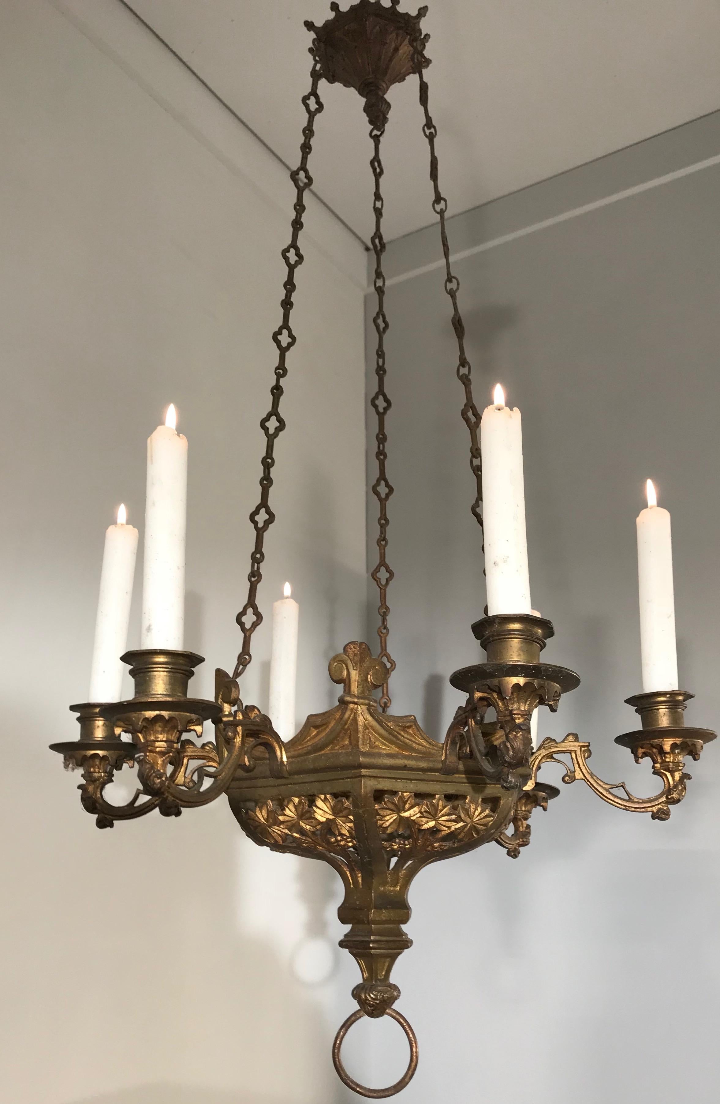 Handcrafted and practical size chandeliers with a great look and feel.

The amount of Gothic elements in these relatively small antique candle chandeliers, combined with their beautiful shapes and patina make this pair an absolute joy to own and