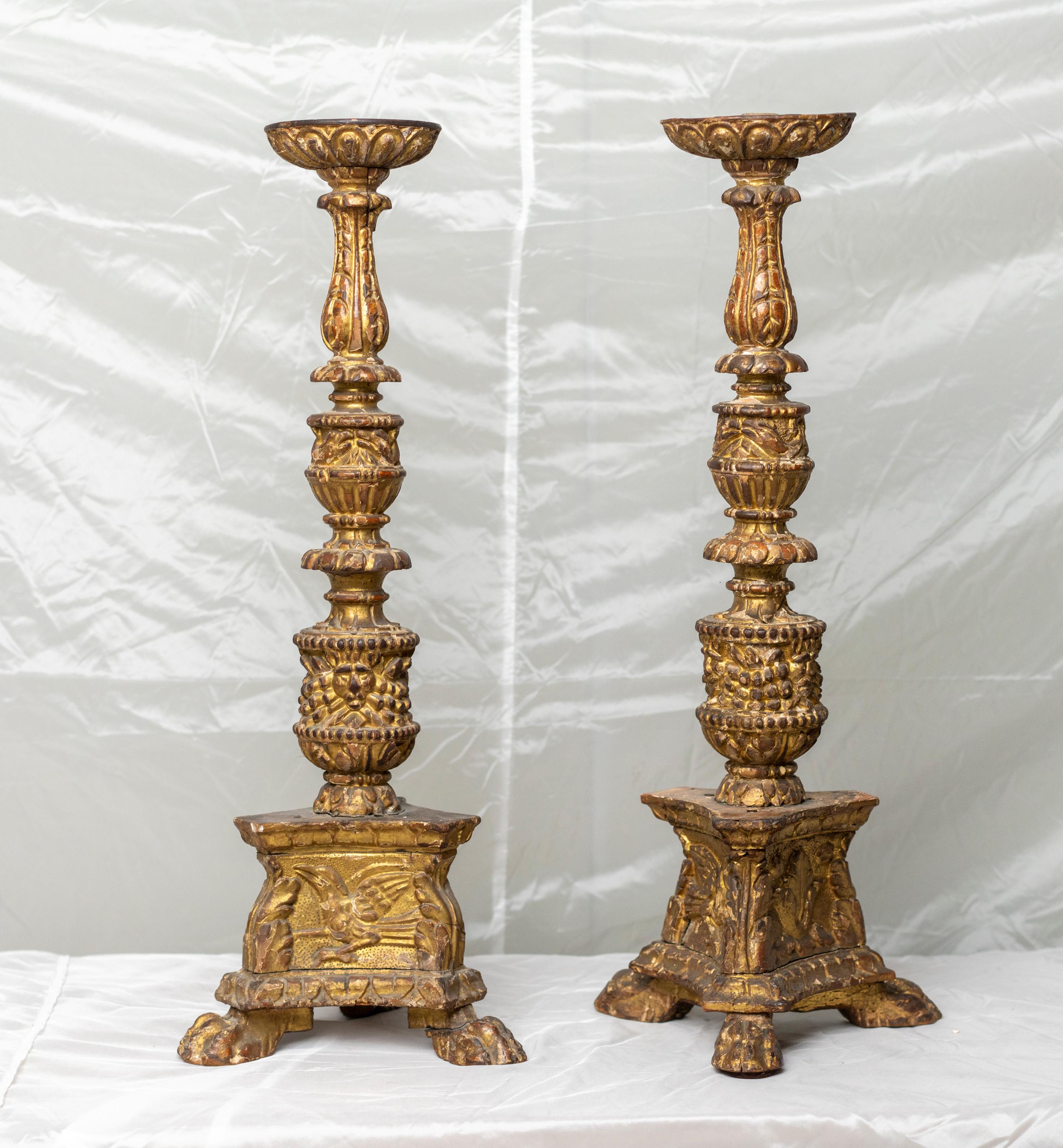 Rare pair of Louis of XIV period gilt wood carved candlesticks carved with lions head and birds resting on a tri pod feet.