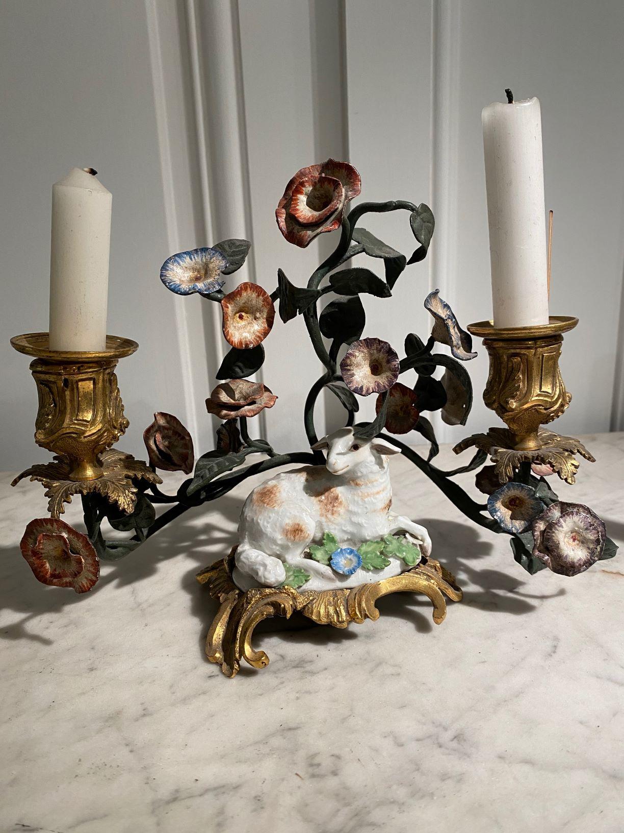 Rare pair of Louis XV gilt-bronze mounted lying sheep Meissen porcelain two-lights candlesticks rests on a Rocaille openwork gilt bronze base and decorated with foliage and Polychrome flowers in lacquered tole.


France
18th century, Louis XV