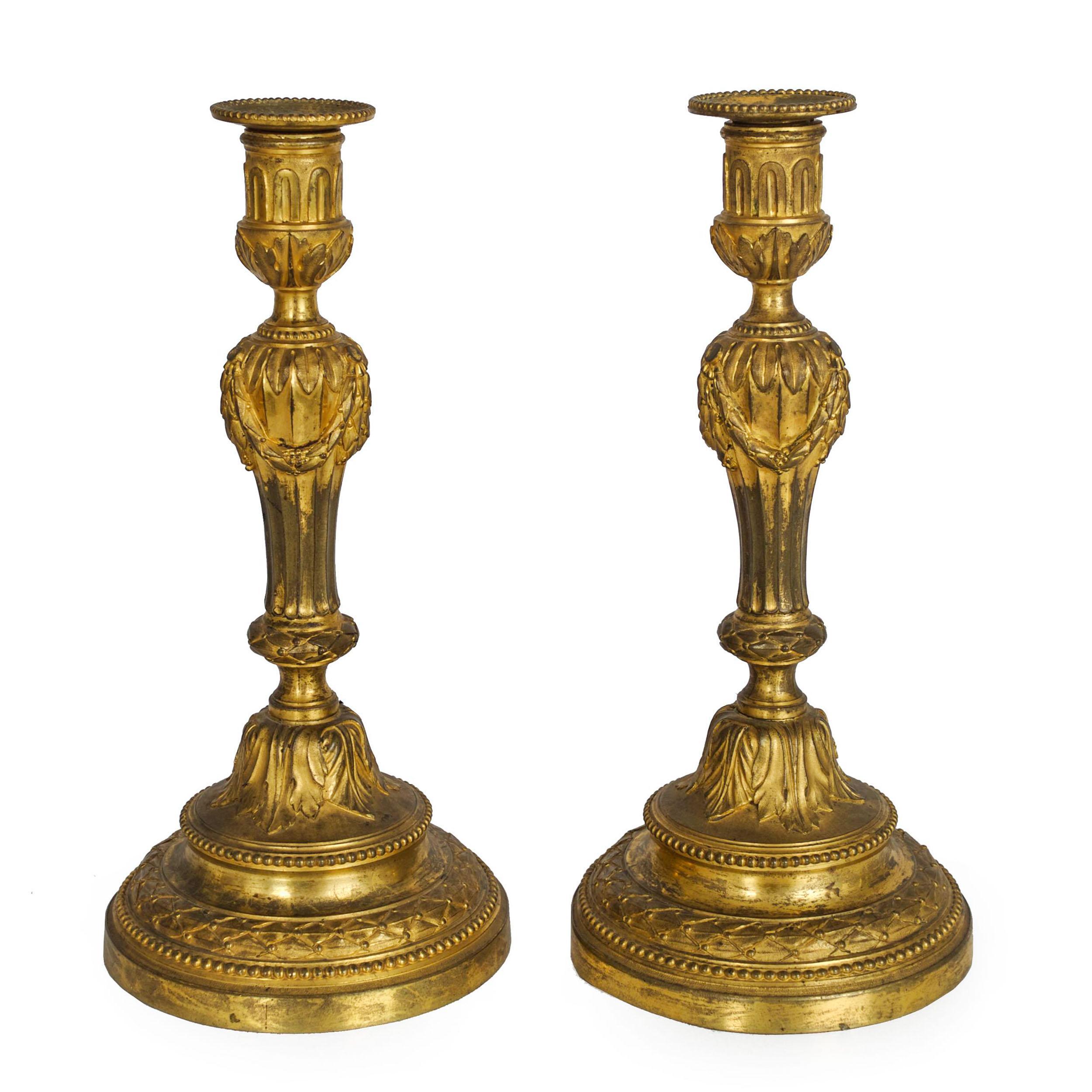 Rare Pair of Louis XVI Period Ormolu Candlesticks, France, circa 1770
Item # C1040271

An incredibly fine pair of ormolu bronze candlesticks from the Wildenstein Collection, they feature a fluted baluster stem draped with fruiting garlands around