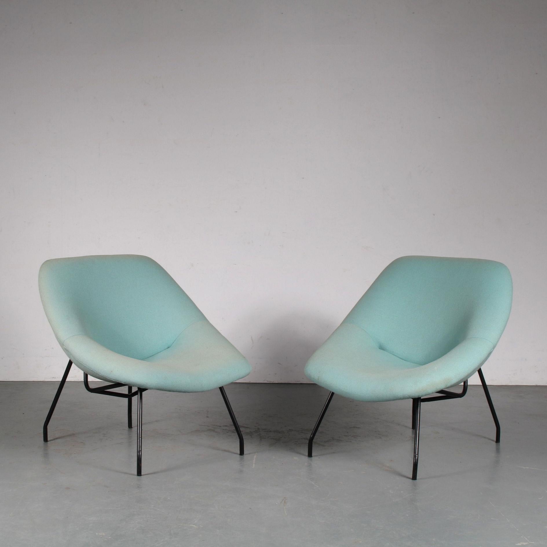 A beautiful pair of easy chair manufactured by GAR in France around 1950.

They have thin black lacquered metal bases with green / blue fabric upholstery. A beautiful combination of materials and colours that gives the set a unique style! They