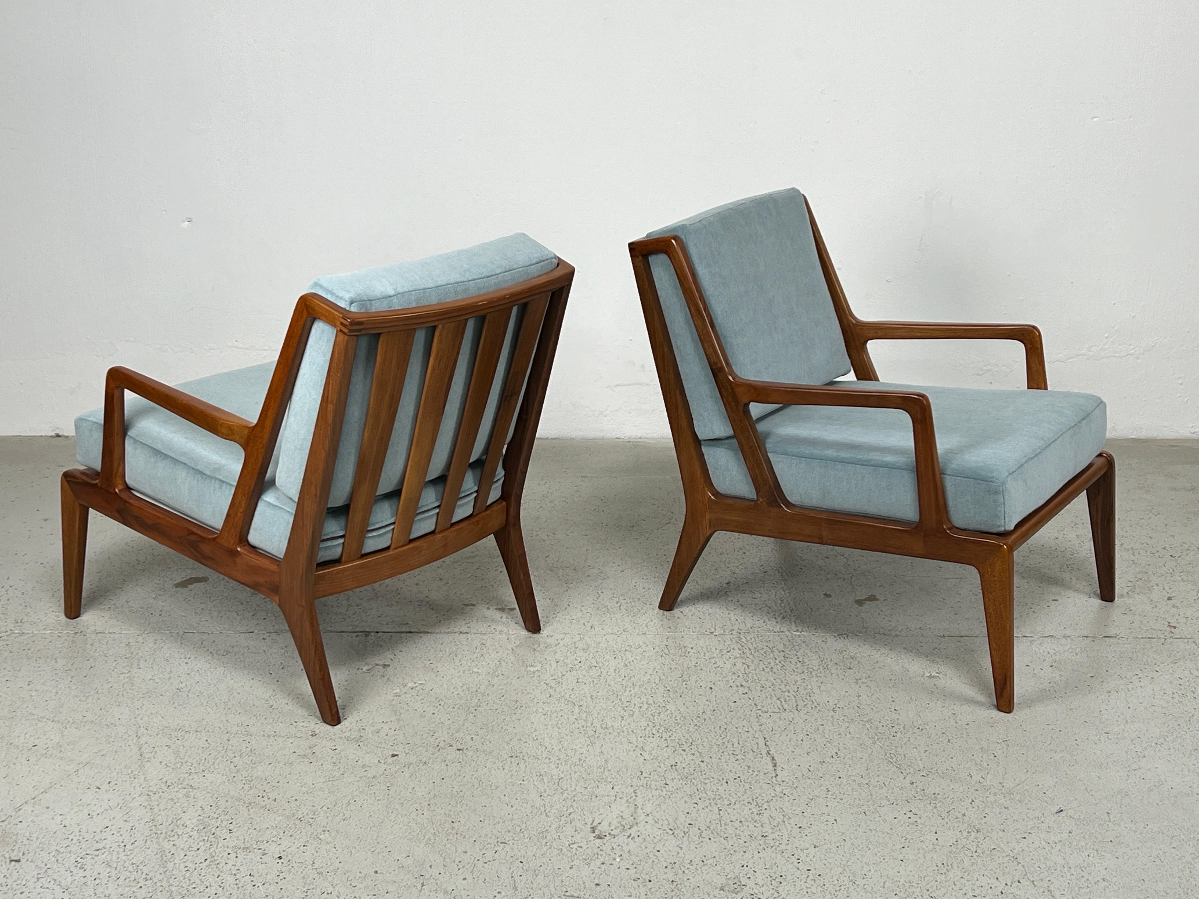 A rare pair of walnut lounge chairs model #255 for Singer and Sons. These were designed by either Carlo Mollino, Gio Ponti, Carlo de Carli or Bertha Schaefer. 