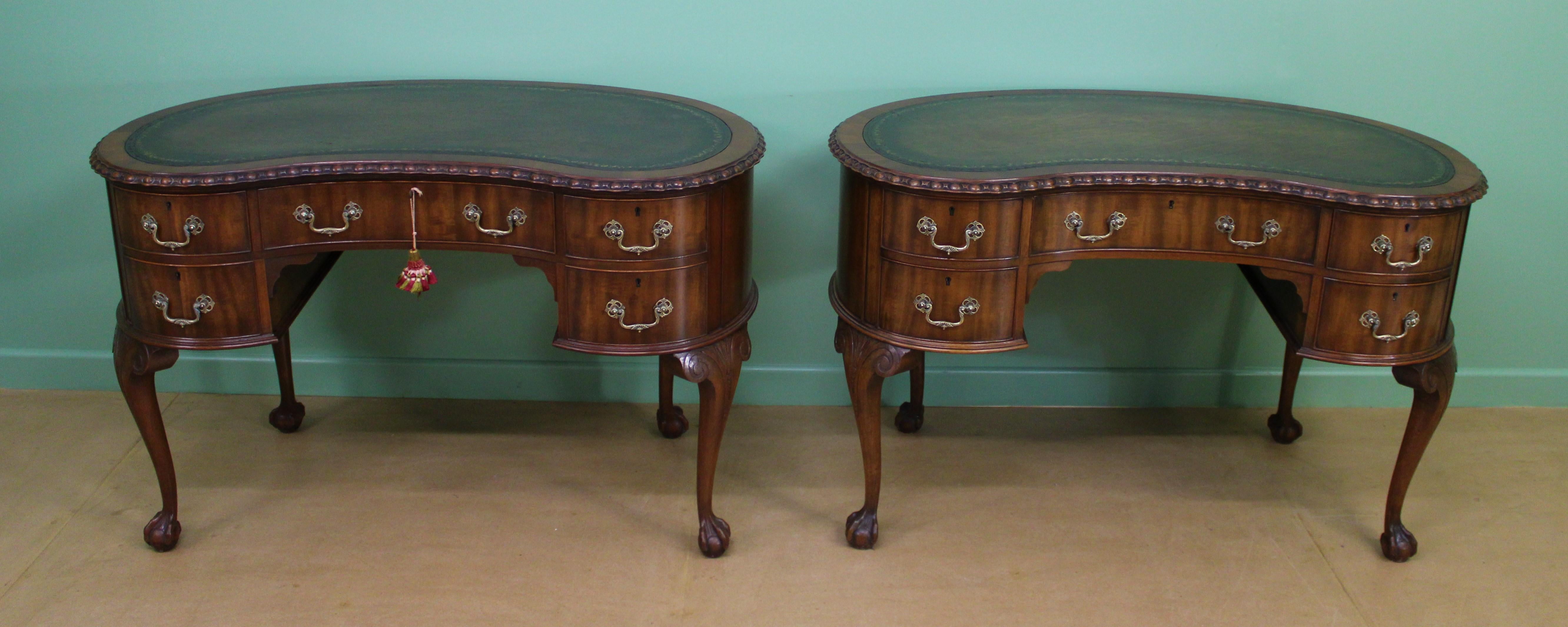 A rare and splendid pair of kidney shaped writing desks by the renowned cabinet makers Waring and Gillow. Of excellent construction in the manner of Thomas Chippendale. Made in solid mahogany with attractive mahogany veneers and oak drawer linings.