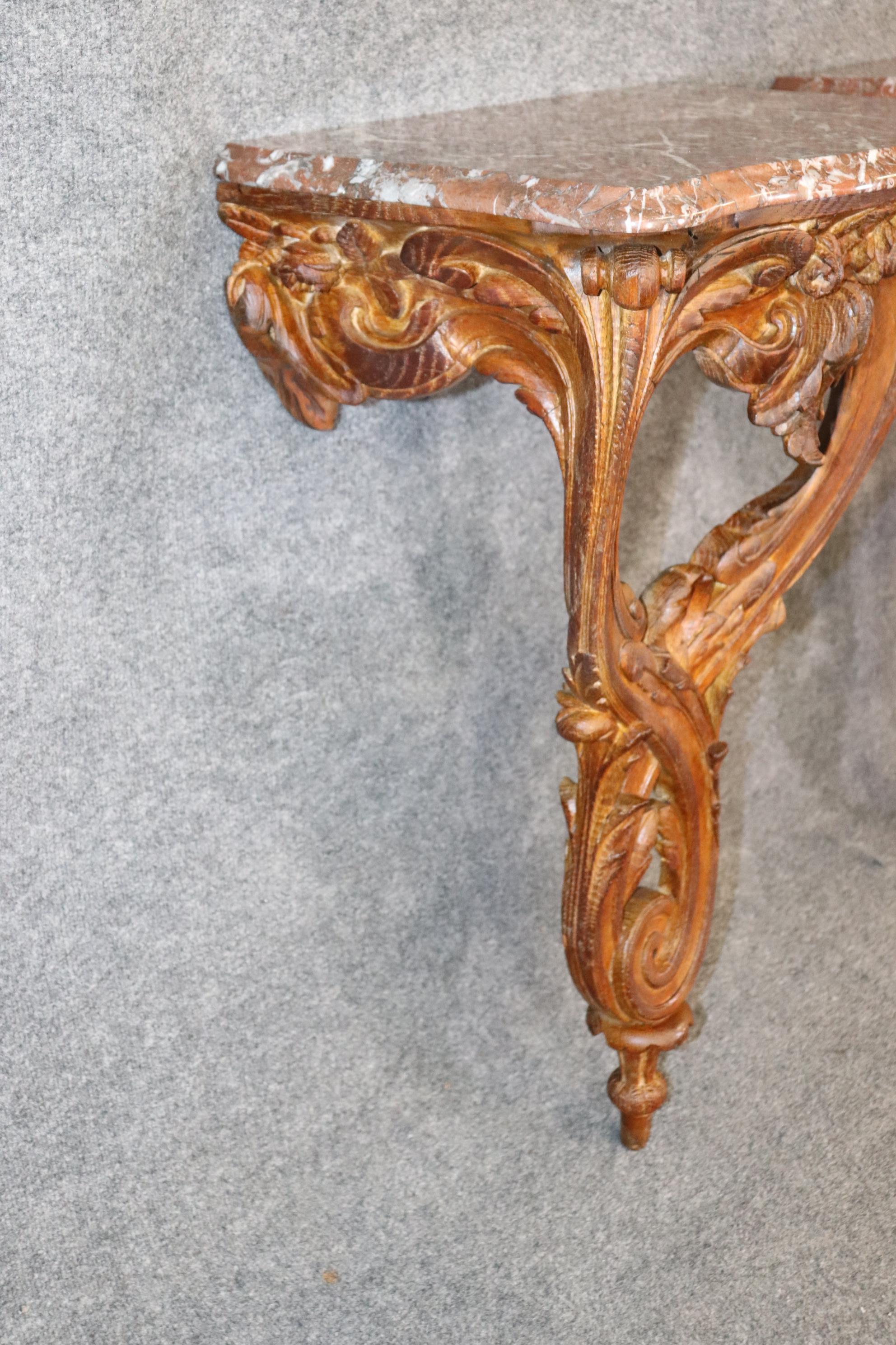 Dimensions- H: 33in W: 20in D: 14 1/4in 

This Incredibly rare Pair of Maison Jansen oak marble top wall hanging consoles are nothing but exceptional! If you take a look at the photos provided you will see the attention to detail throughout both