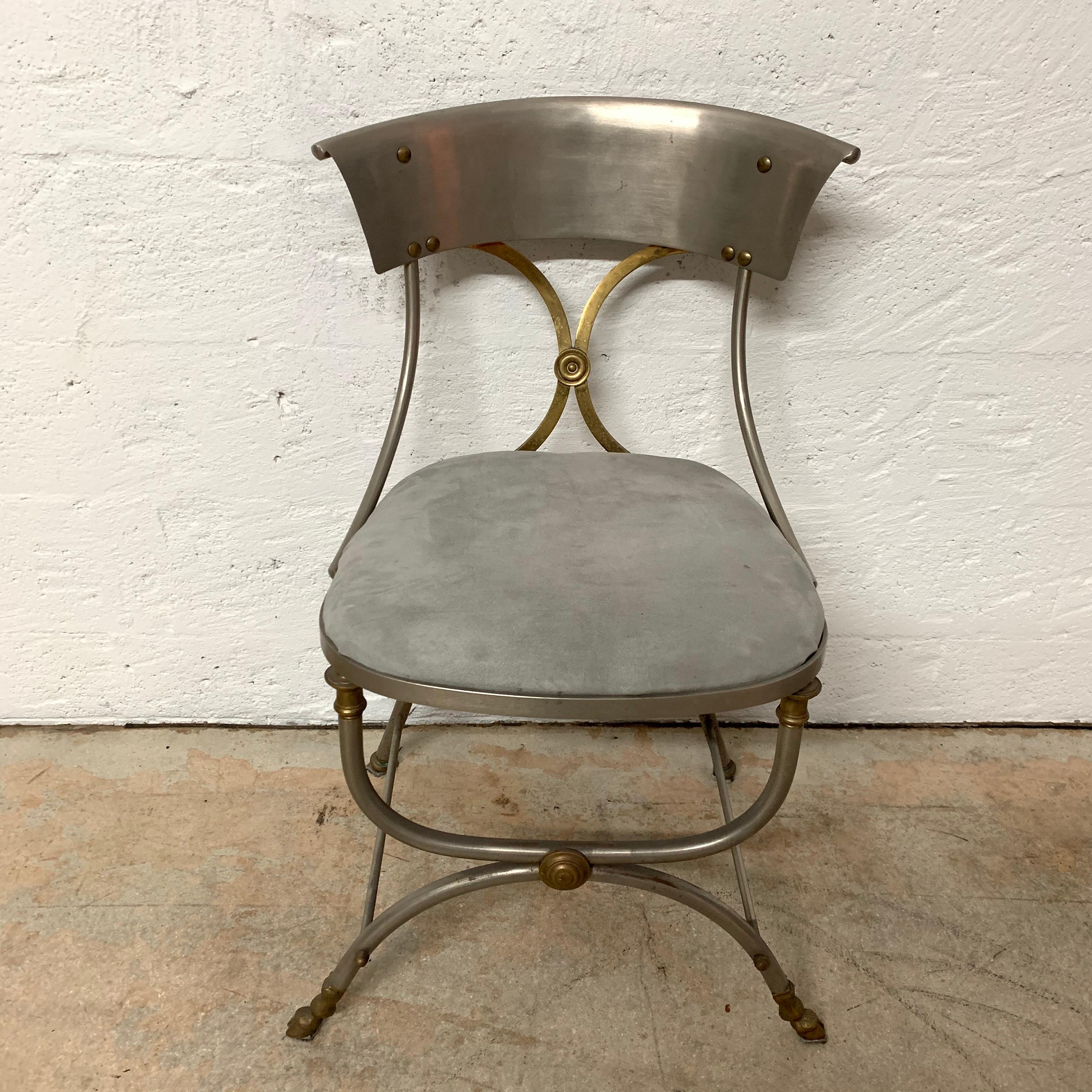 Set of two Directoire style side or dining chairs rendered in steel and brass bronze with grey ultrasude seats and hoof feet by Maison Jansen.