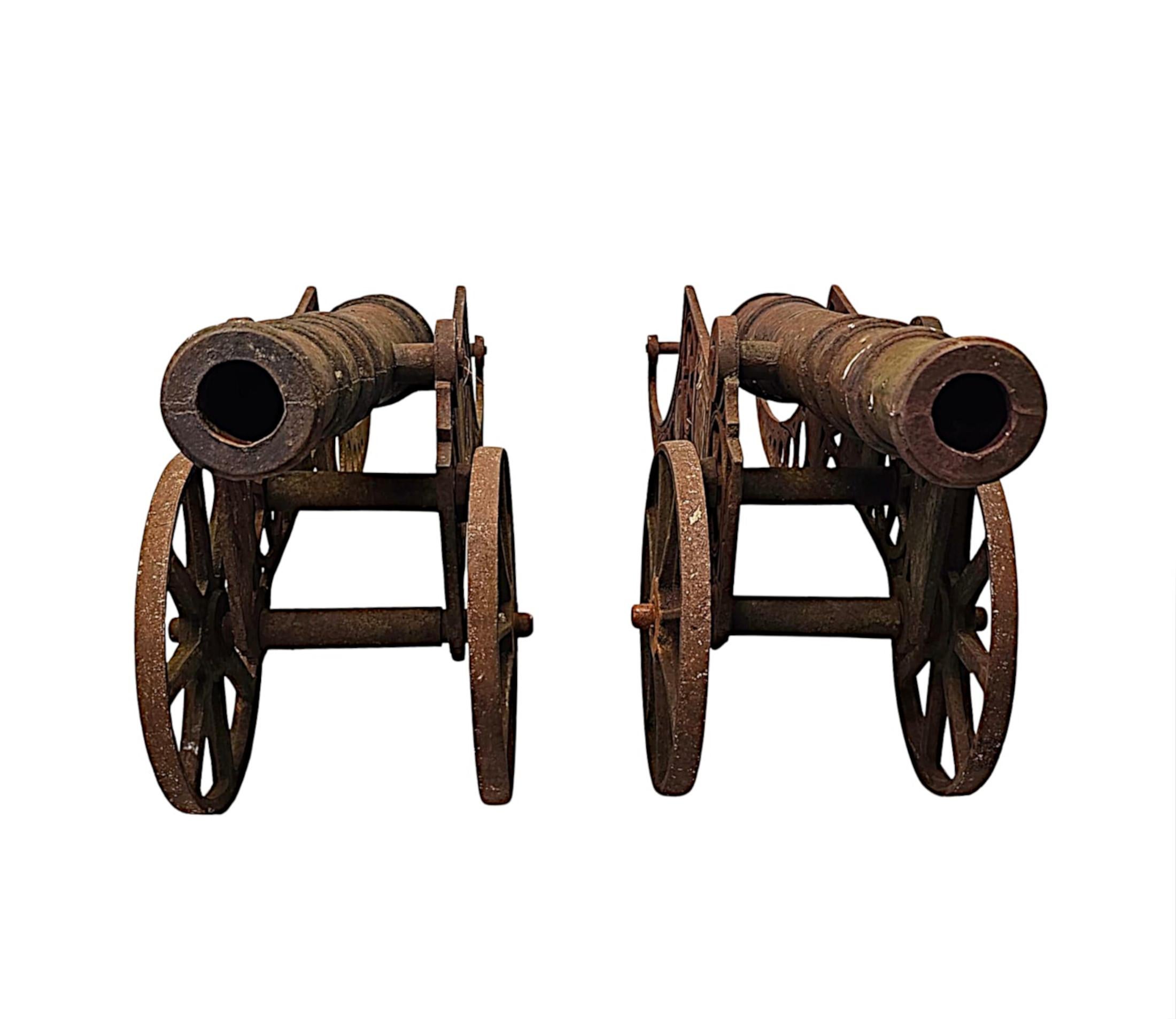 A very rare pair of mid 20th Century garden heavy cast iron barrelled signal cannons mounted on two wheeled carriage bases.  This fabulous pair are of grand proportions, finely cast and of exceptional quality with superb patination and colour.