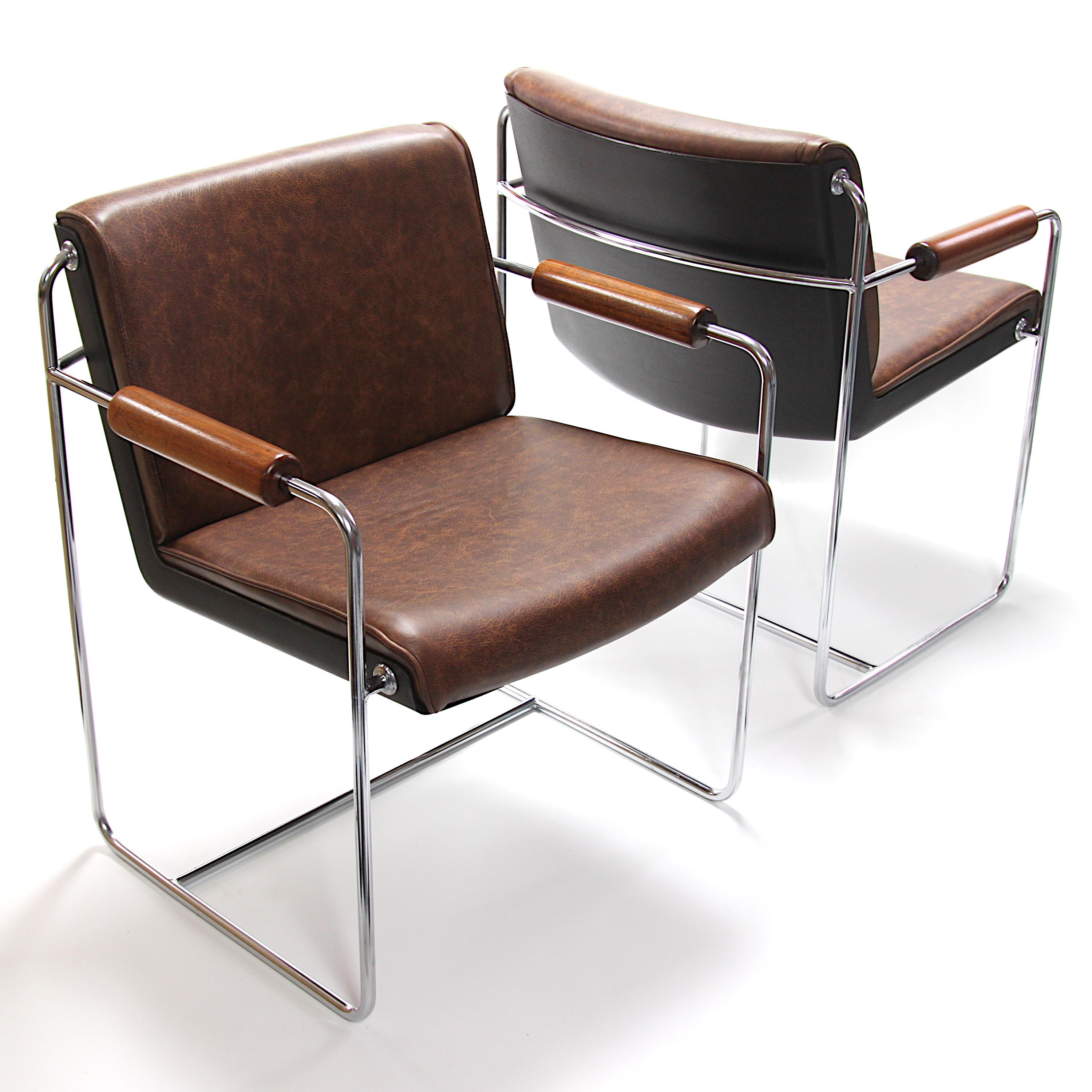 Wonderful pair of rare 1960s AFKA guest/side chairs by Krueger metal products. These chairs feature a white fiberglass shell, chrome steel frame and solid walnut armrests. Chairs have been freshly restored and now feature gorgeous distressed leather