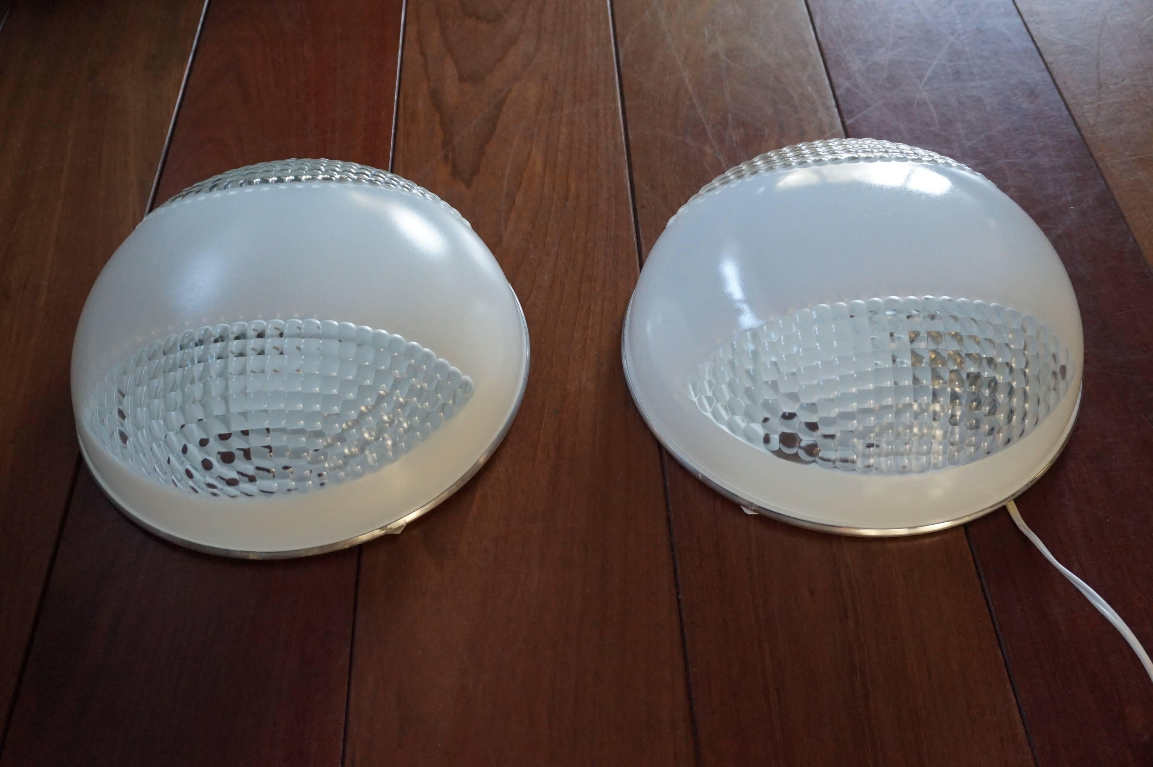 For the collectors and interior designers.

They say that there is a first time for everything, but never had we expected to find an unused and rare pair of Holophane flush mounts from the midcentury modern era. The sockets of these Holophane