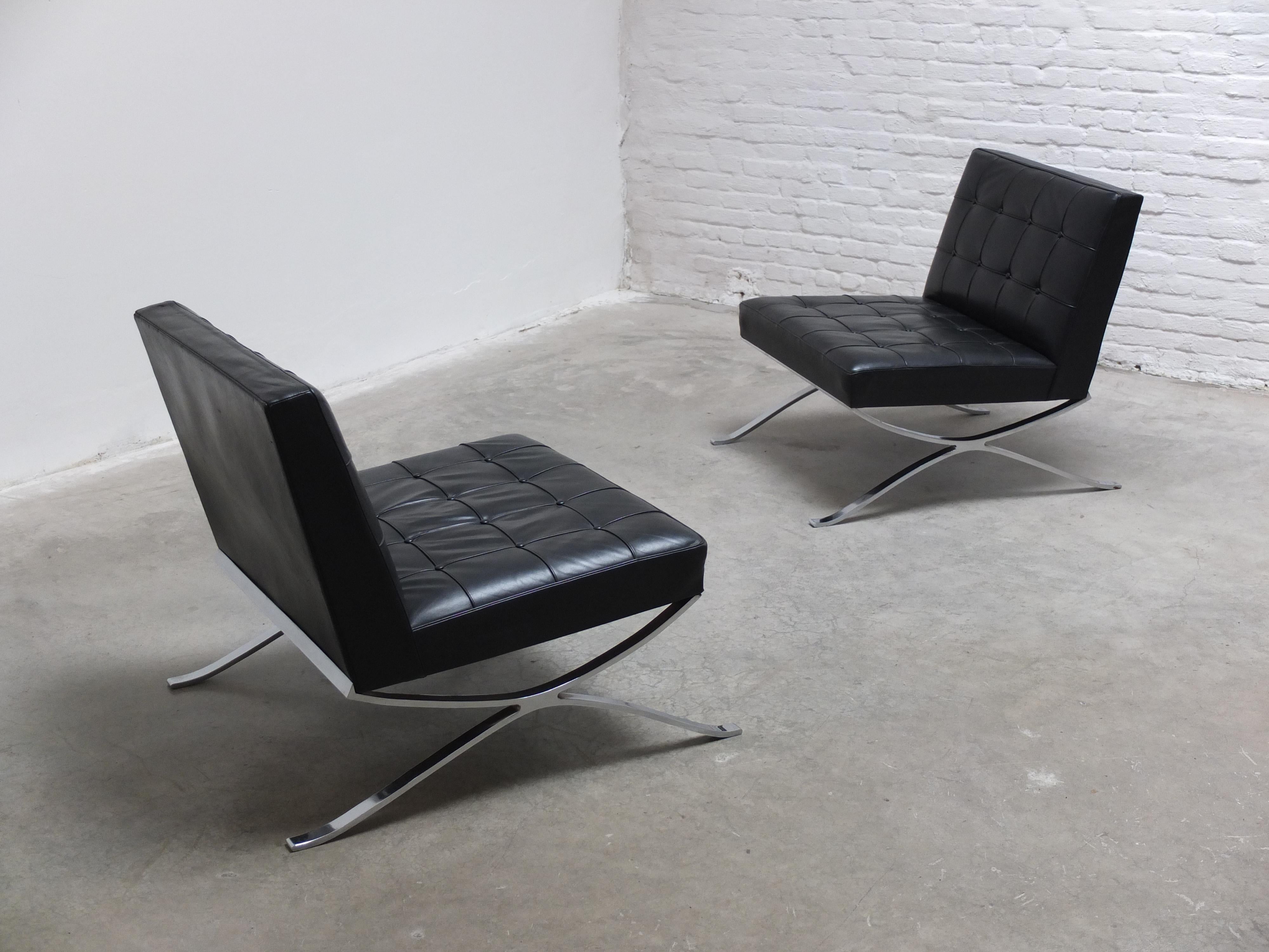 Exceptional pair of lounge chairs made by Hans Kaufeld around 1960. These chairs are hard to find and clearly a tribute to the iconic Barcelona chairs by Mies Van Der Rohe which inspired many designers from the period. The chairs have a beautiful