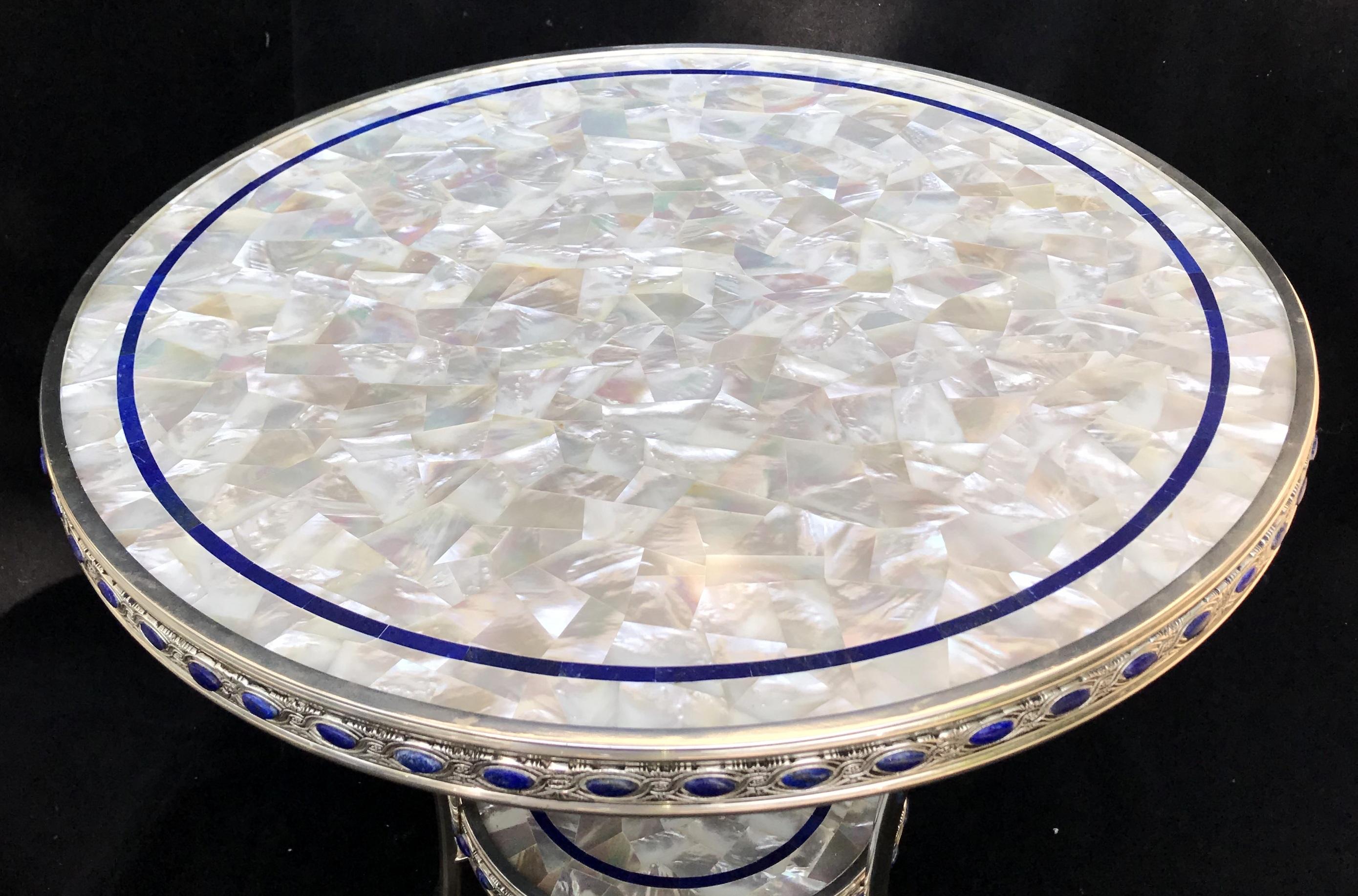 Wonderful and rare pair of neoclassical mother-of-pearl and lapis inlaid with polished nickel silvered bronze round two-tier Guéridon tables with paw feet and jeweled border.