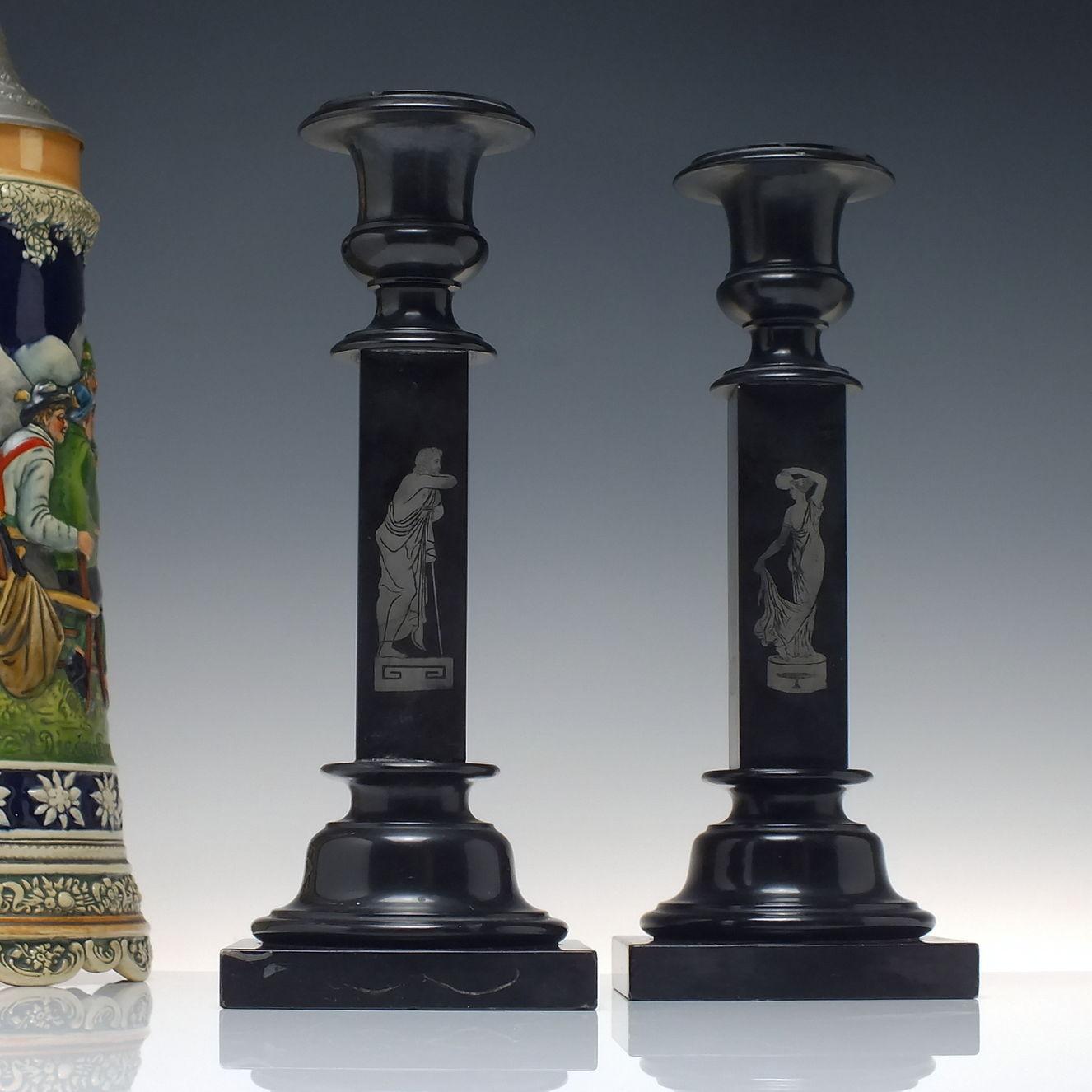 Technical Description 

A rare pair of Ashford Black Marble candlesticks produced in the mid 19th century in Derbyshire. Each candlestick has a different set of four etched classical figures.

You can find some excellent inlaid and engraved