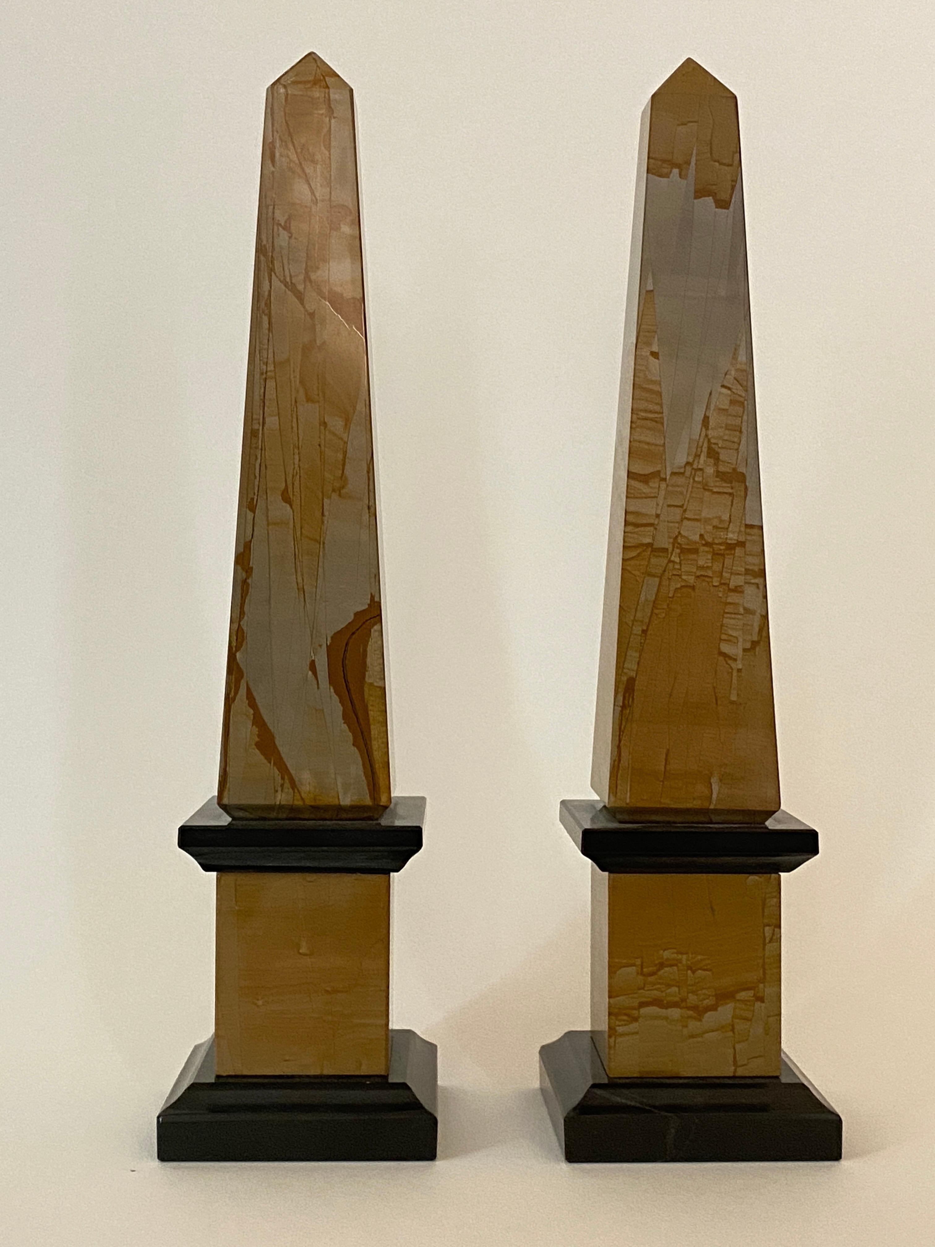 Rare pair of Neoclassical Italian obelisks in pietra paesine and black portoro marble.

Pietra paesine are very fine stones which, once cut into strips and polished, reveal a predominantly beige, ocher, red-brown or blue-green design.

The design is