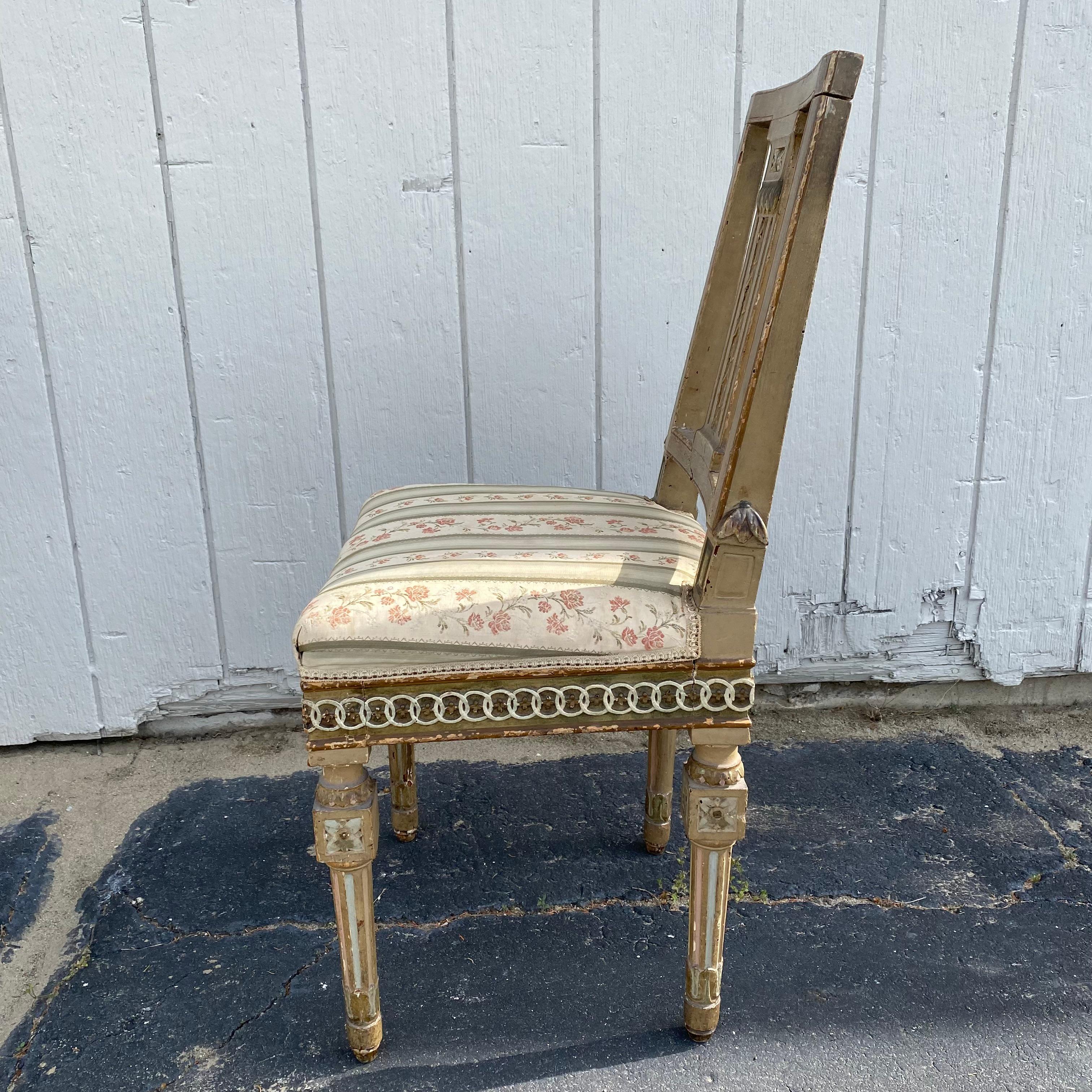 Really early set of period 18th century French neoclassical chairs with original paint and classic linked ring carving on the apron with floral embellishments at the top of each leg. It is rare to find a pair as early as these in such amazing shape.