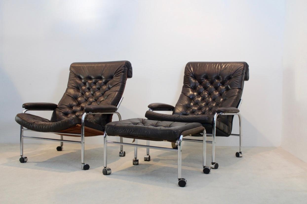 An extremely rare and beautiful pair of 1970s original Noboru Nakamura leather button back lounge chairs, with a matching footstool in chocolate brown leather. The ‘Bore’ called chairs and stool have a light chrome tubular frame with removable