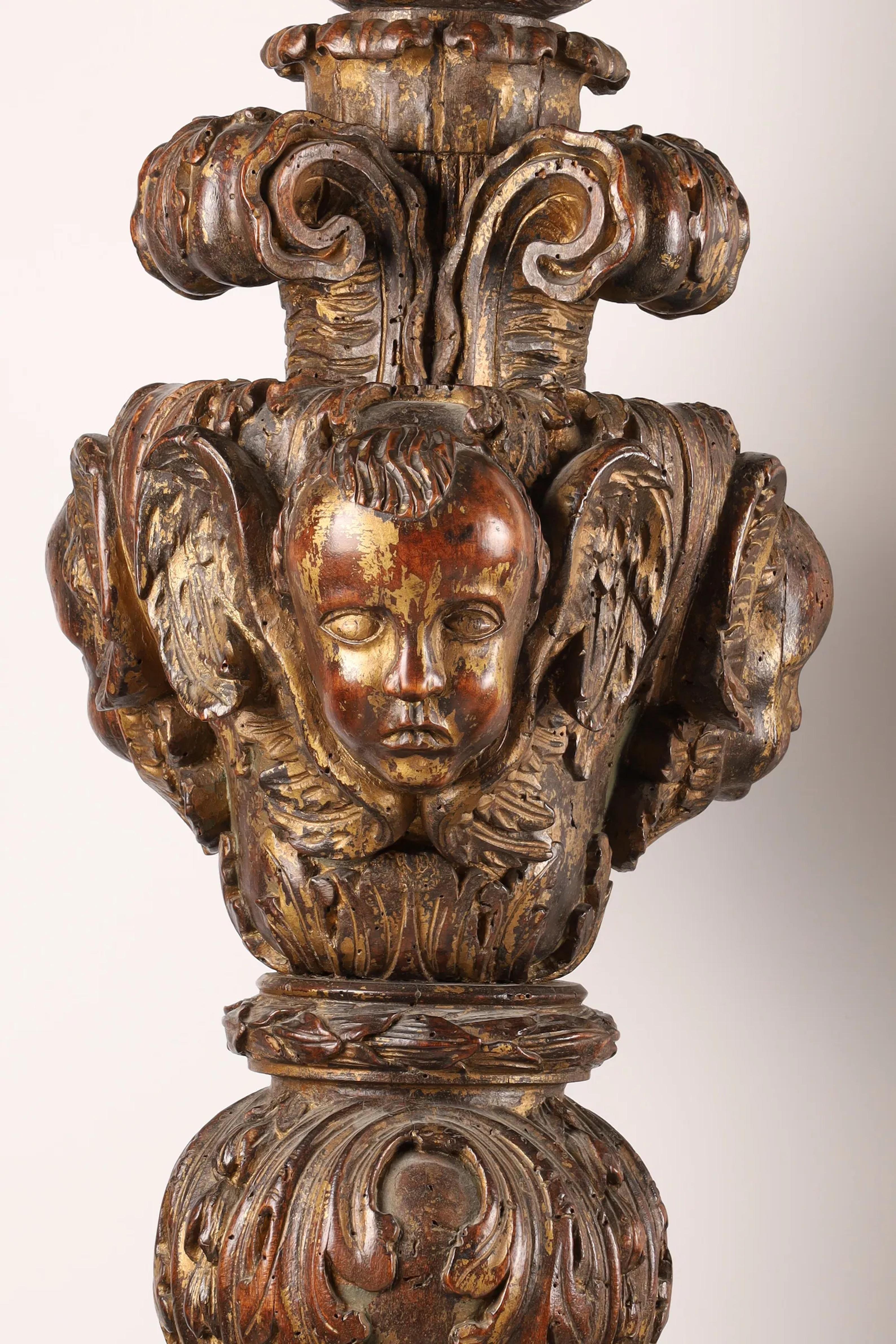 Pair of Italian carved wood torcheres with traces of gilt paint Italy: