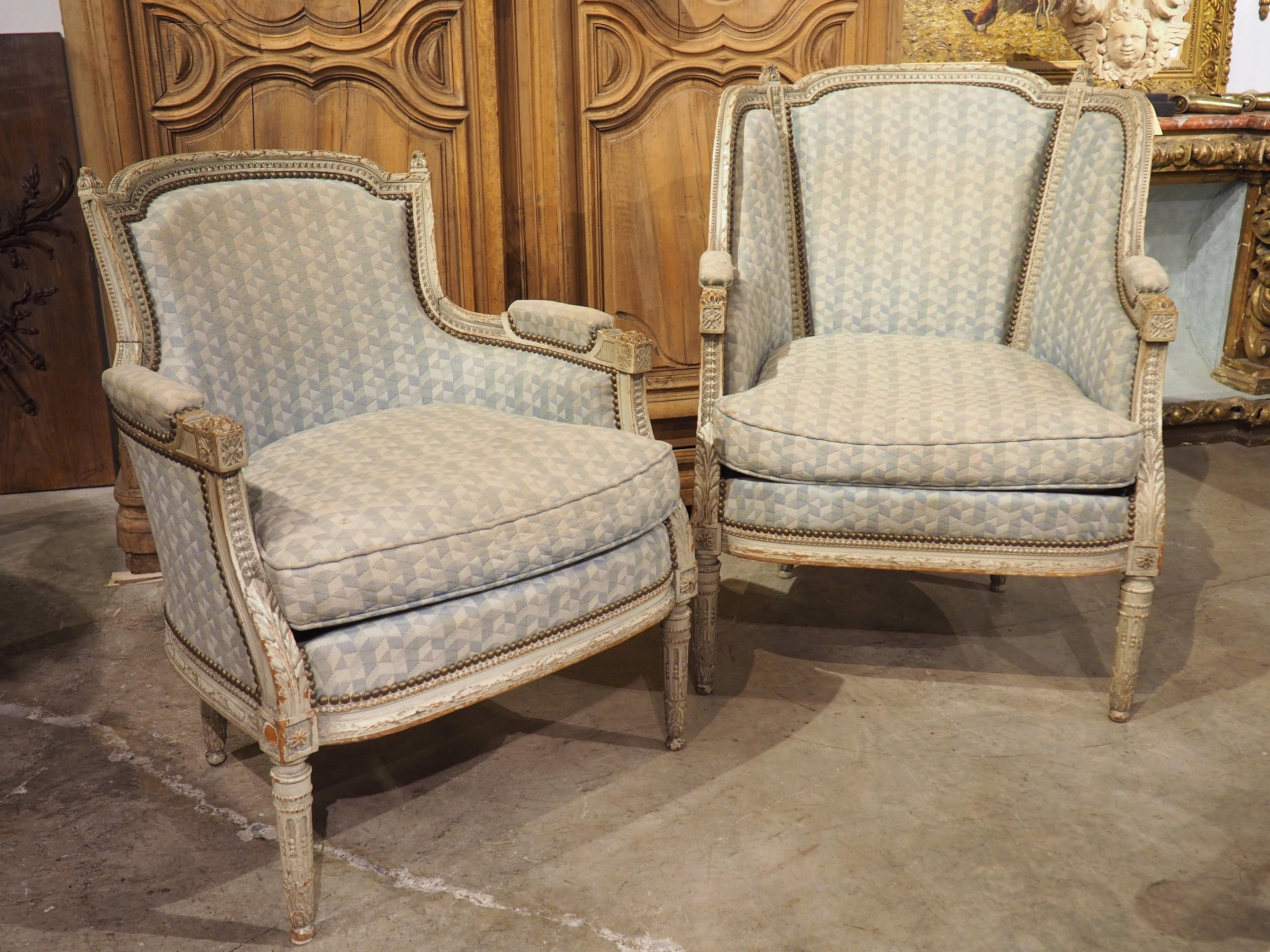 Period Louis XVI armchairs, such as this rare pair of His and Hers Bergère chairs dating to circa 1780, were markedly different than seating from previous styles. Less ostentatious than its predecessors, the appeal of Louis XVI chairs is the subtle