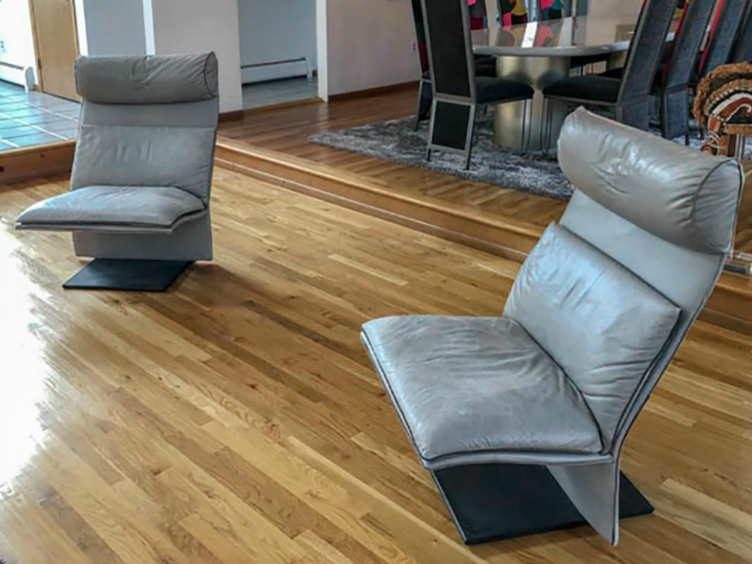 Rare pair of Postmodern Italian leather chairs by Fratelli Saporiti. Chairs have a beautiful cantilevered design. Chairs are a butter soft gray leather on a black steel base. 

The leather shows gorgeous patina from age and use. There is no real