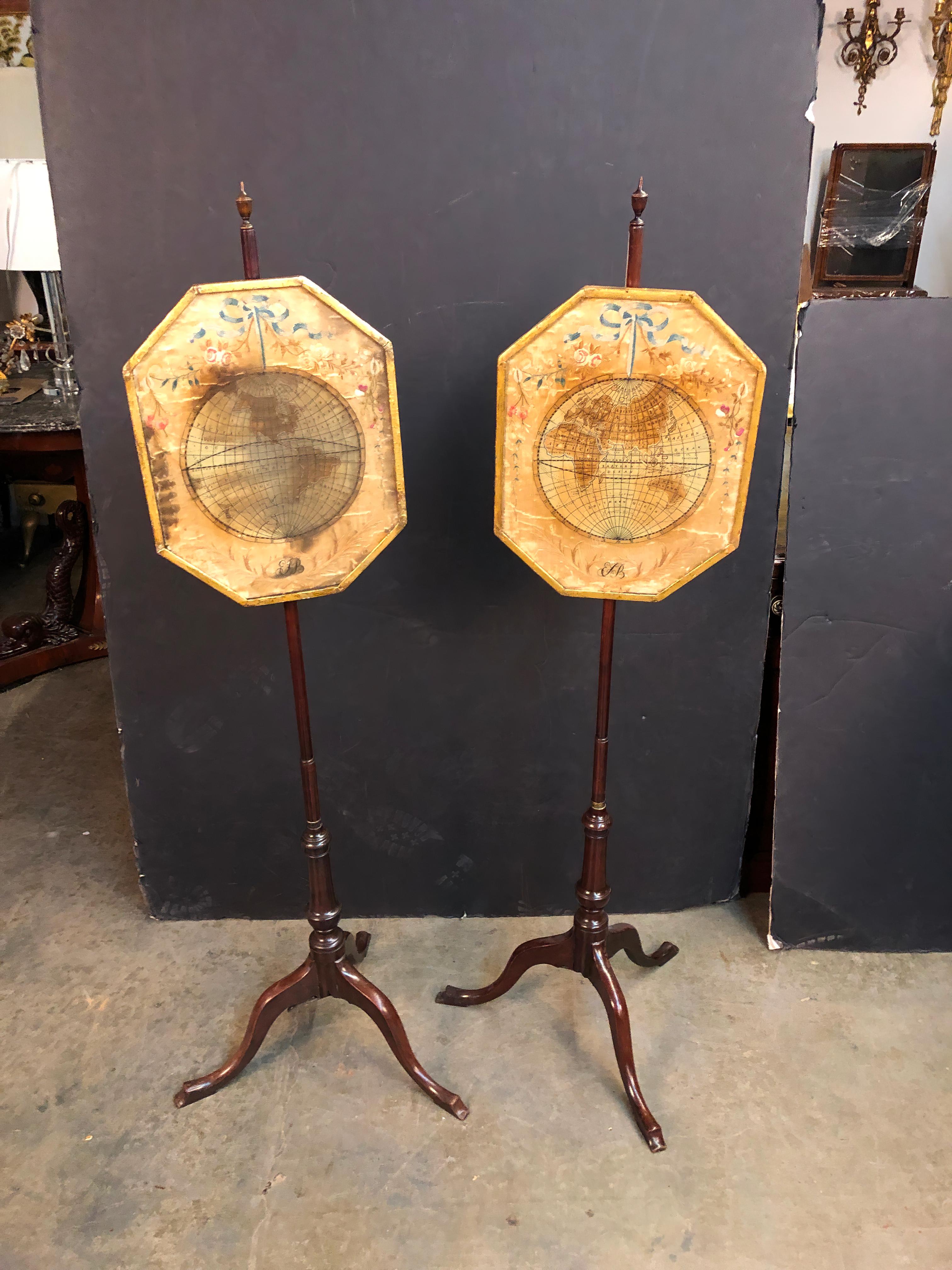 A rare pair of Queen Anne mahogany pole screens with urn finials and embroidered silk work depicting the eastern and western hemispheres of the world as of the 18th century. 
Possibly American.