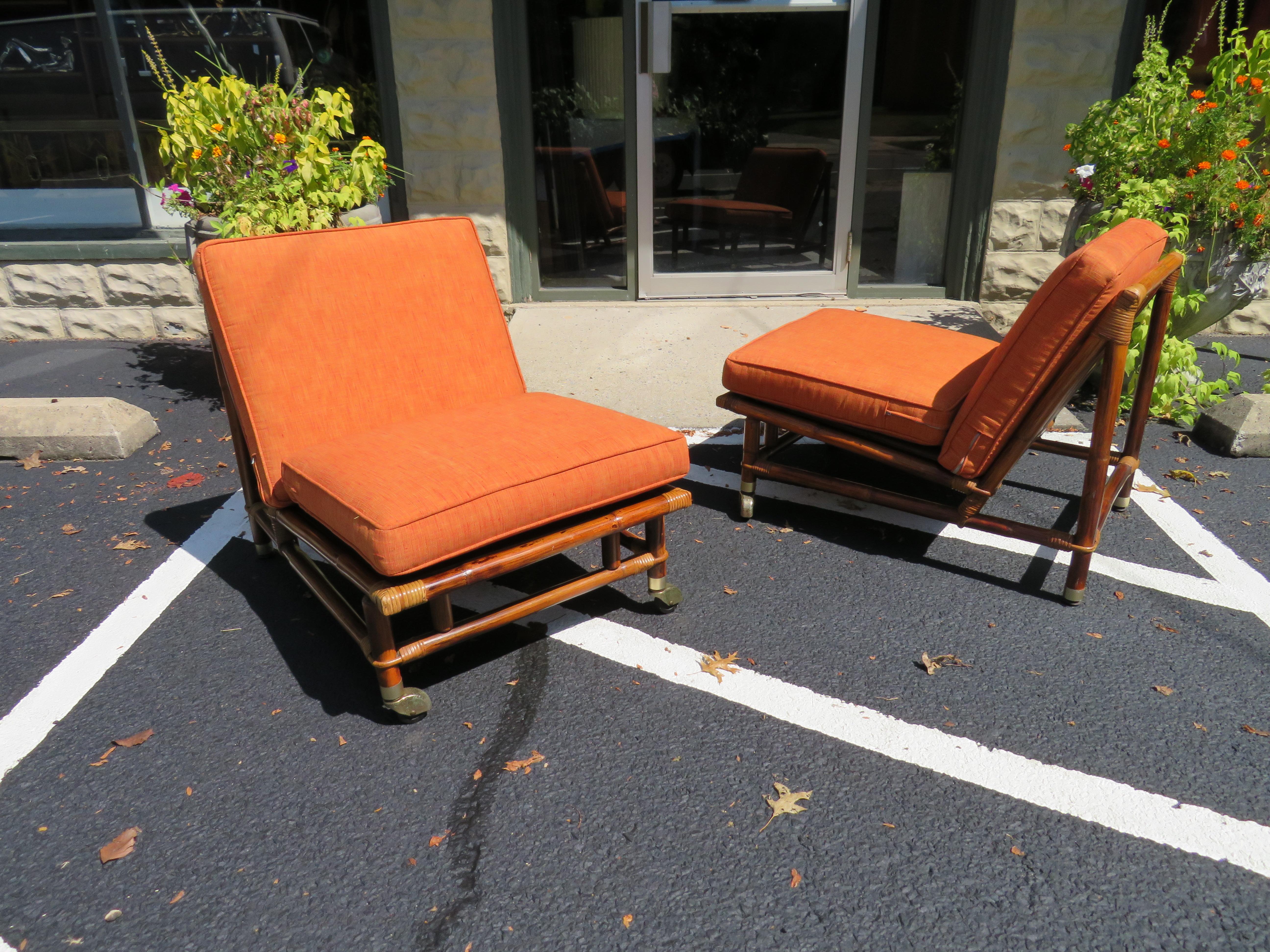 An exceptional pair of vintage rattan Campaign style slipper lounge chairs. Fabulous design, quality and craftsmanship. Aged to absolute perfection! These unusual pieces were a part of the 