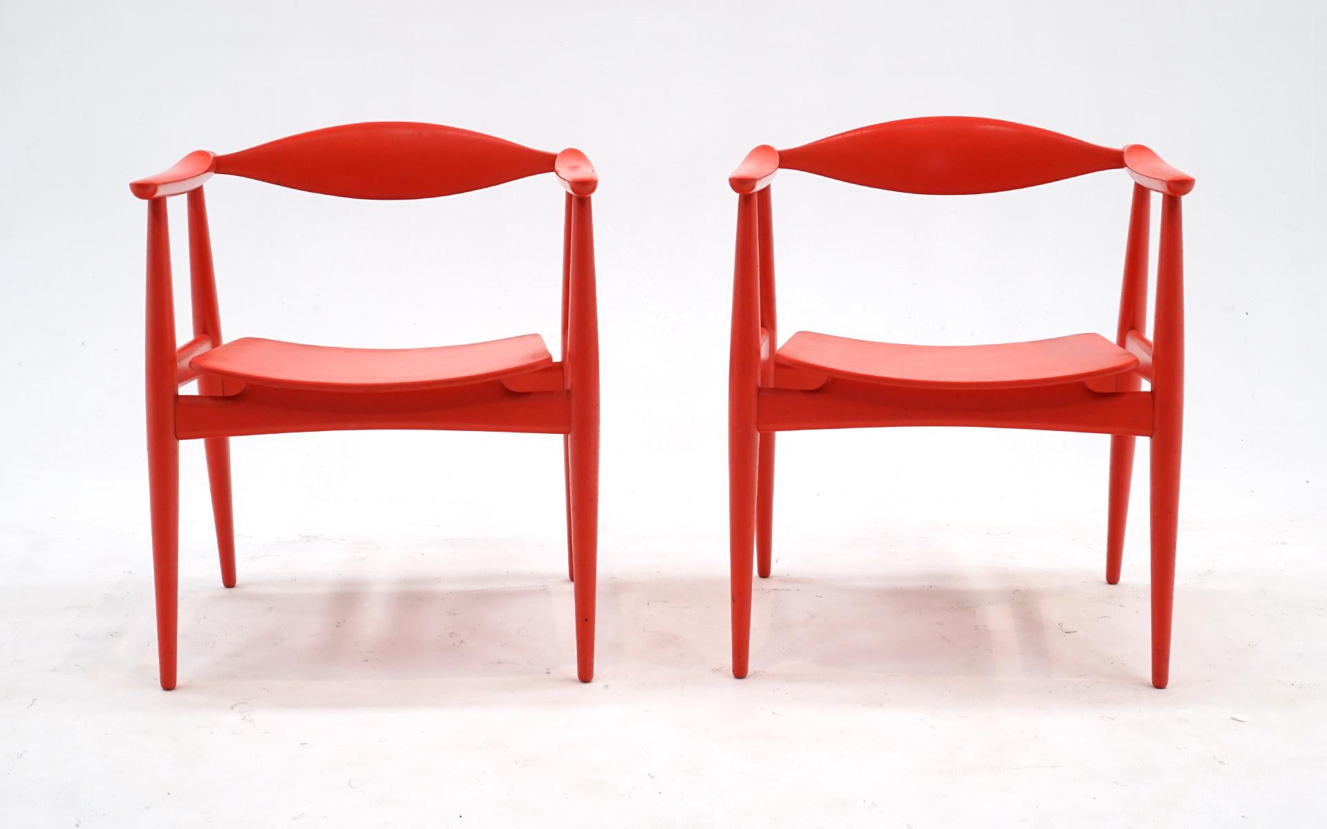 Very rare and desirable pair of red side chairs designed by Hans Wegner for Hansen and Son, Denmark, 1950s.  These are in very good completely original condition and were acquired from the original owner.  It's obvious they were very well cared for.