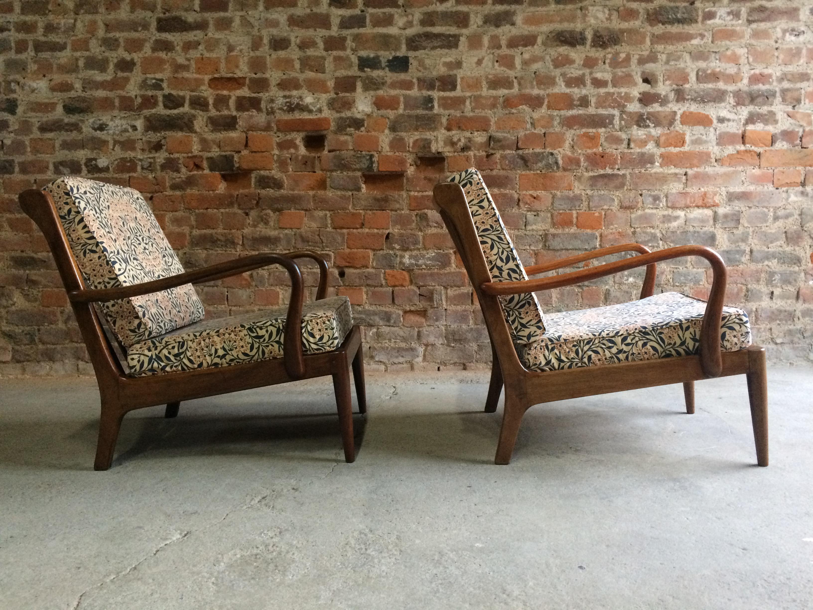 Robert Heritage for George Stone of High Wycombe, exceptionally rare pair of lounge armchairs circa 1960s, the frames constructed from afrormosia wood with William Morris upholstered cushion covers, the sculptural form clearly influenced by the