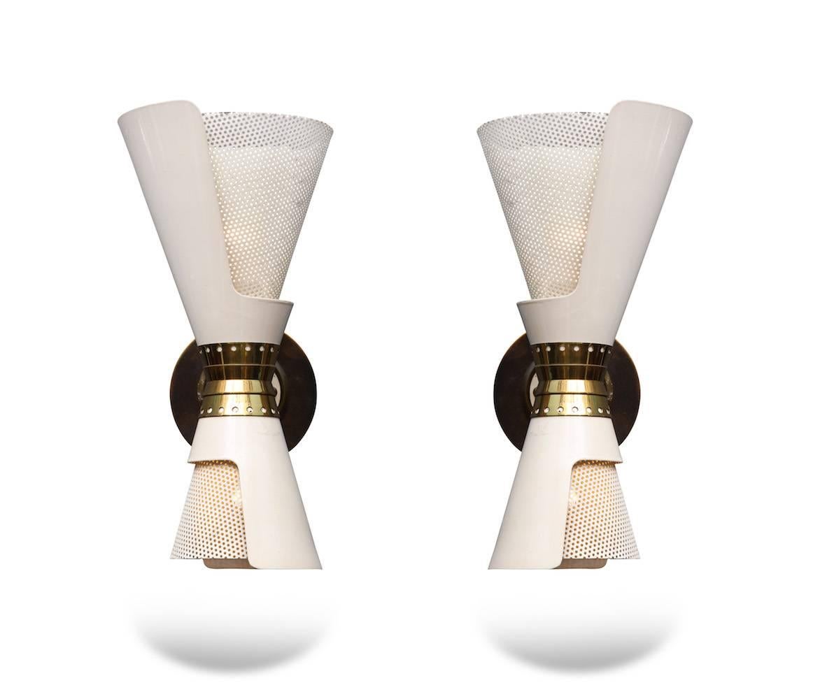 Beautiful pair of double-cone sconces with cut-outs that turn to reveal a mesh reflector. Off-white, painted meal with polished brass mounts. Larger top cone conceals a standard sized socket and the bottom, smaller cone a candelabra socket. New