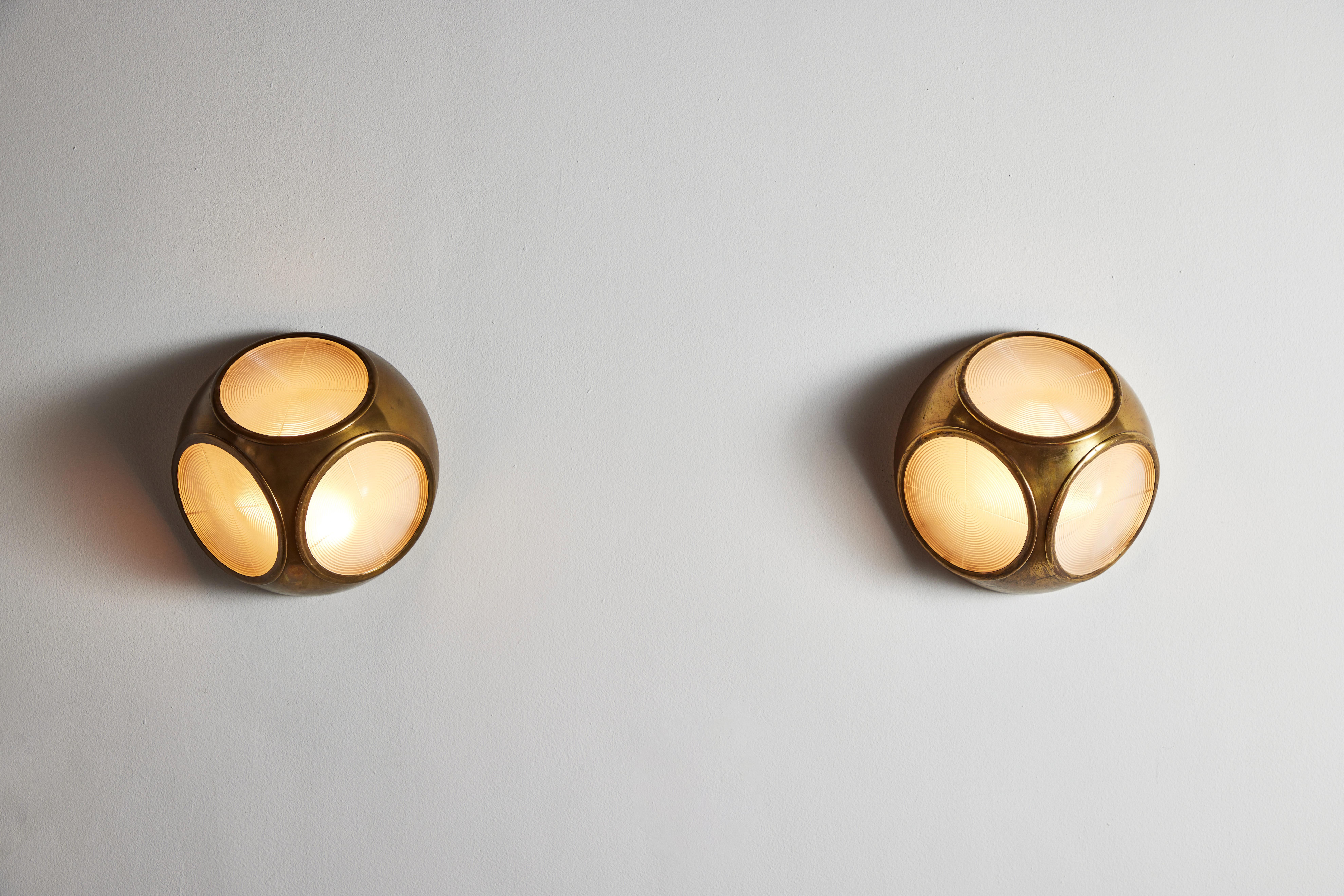 Rare pair of sconces by Atelier Jean Perzel. Designed and manufactured in France, circa 1930s. Faceted brass, glass. Rewired for U.S. standards. We recommend two E12 60w bulbs per fixture. Bulbs provided as a one time courtesy.