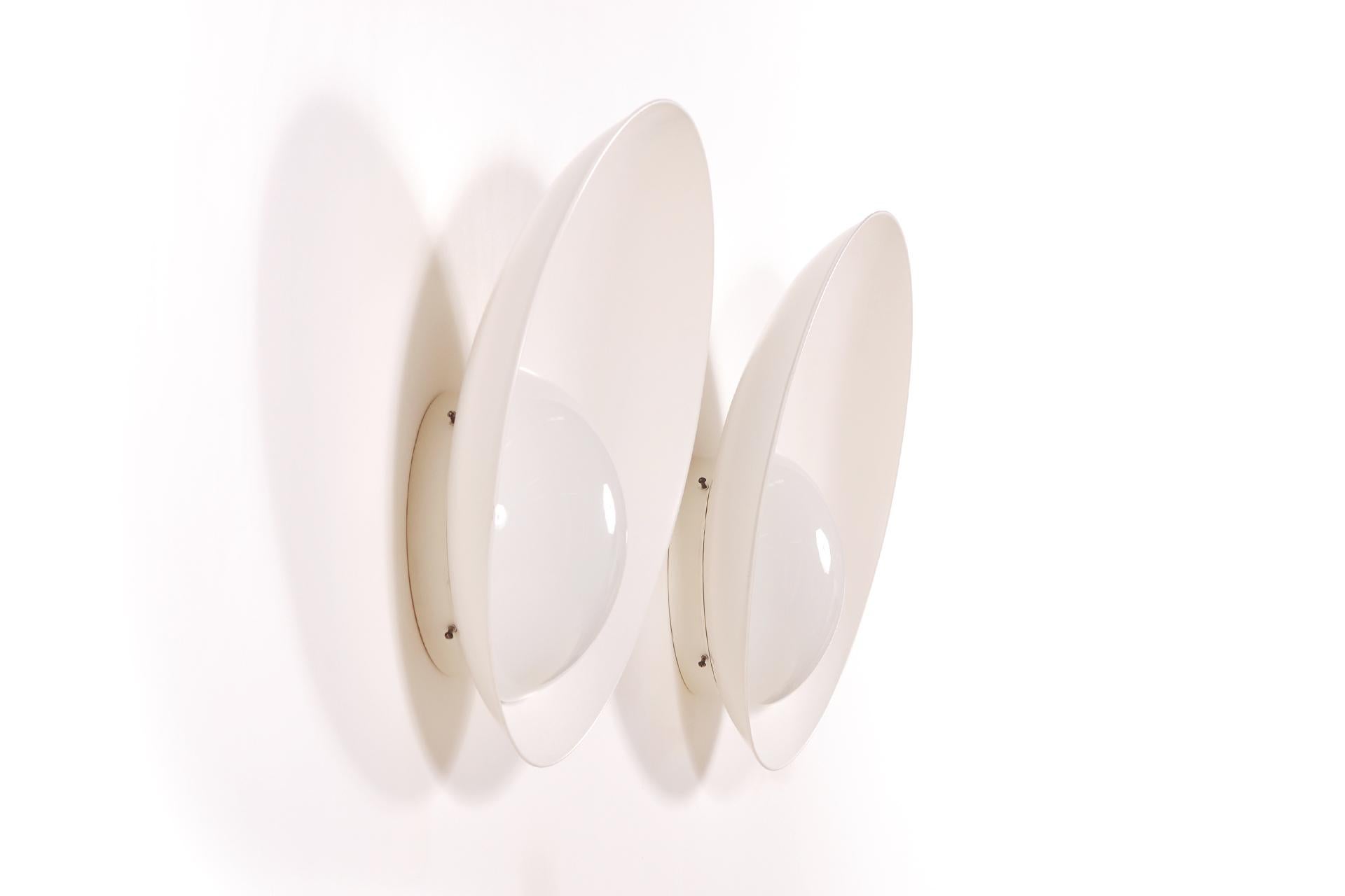 Here is the largest model (60 cm diameter) of the Kastrup Danish airport wall lamp designed by Vilhelm Lauritzen and manufactured by Louis Poulsen, Denmark, 1936. They are made of white painted aluminum and an opaline glass diffuser.