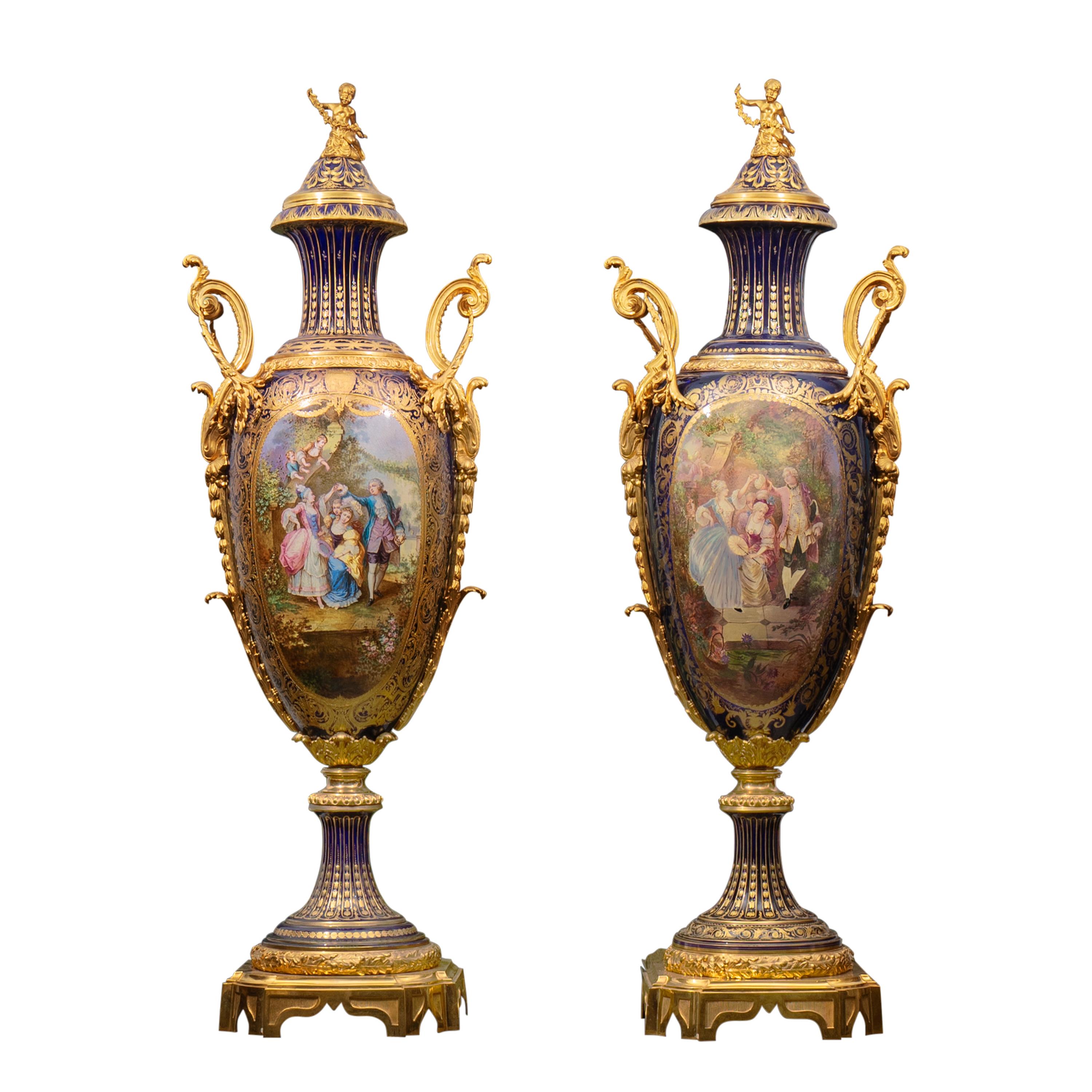 RARE PAIR OF SEVRES STYLE PALACE SIZE GILT-BRONZE MOUNTED VASES 

France, Circa 1860

These Sèvres porcelain urns are truly exceptional, standing out for their monumental size and exquisite craftsmanship, showcasing the renowned deep cobalt blue