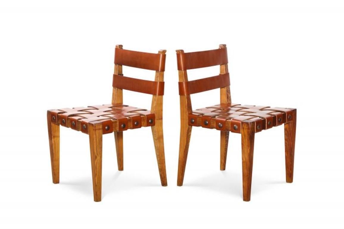 Rare Pair of Side Chairs by Osvaldo Borsani.  Model # 4346/ 4350, open-grain ash frames with dark leather strapping and large patinated metal tacs. A rare and early Borsani design. These chairs have been authenticated by the Archivio Osvaldo