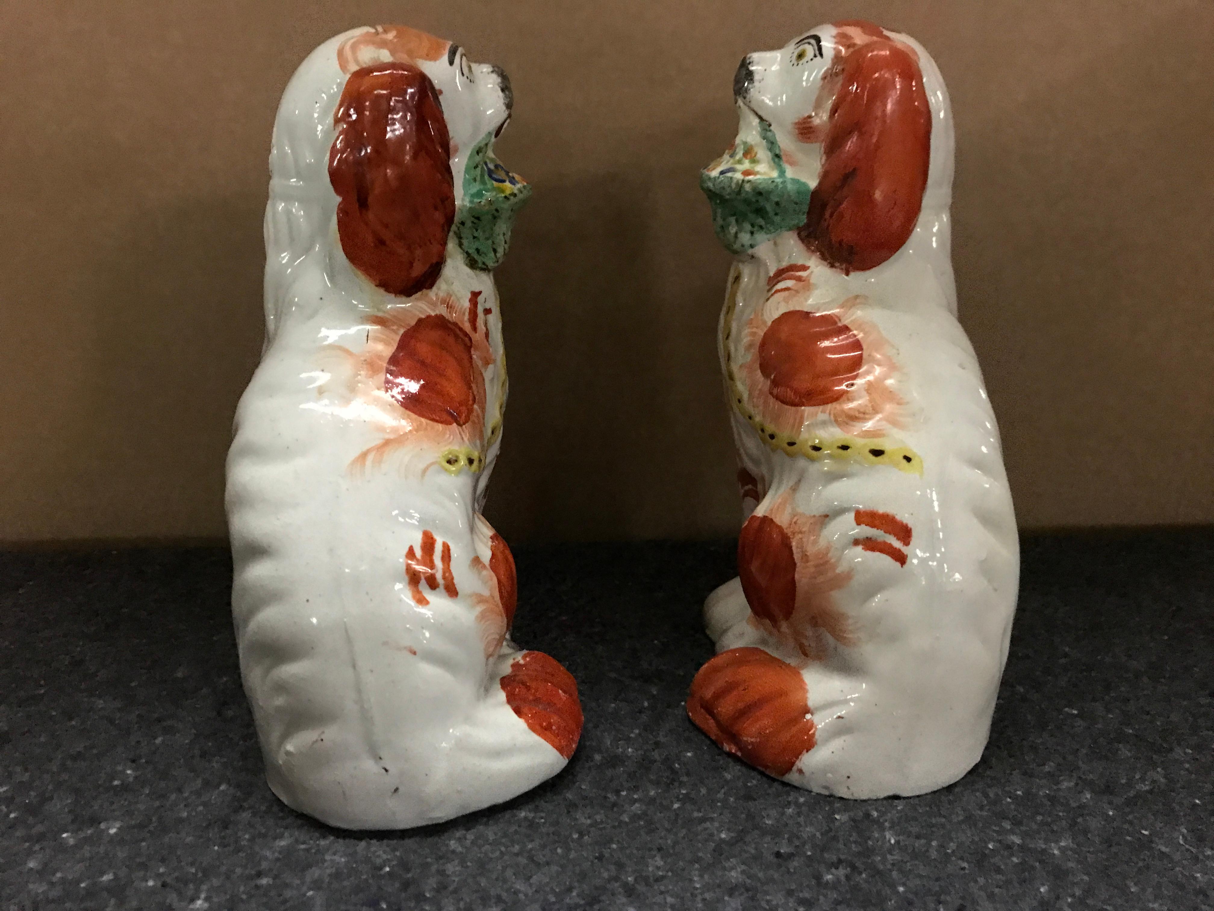 High Victorian Rare Pair of Staffordshire Seated Red Spaniels with Baskets of Flowers For Sale