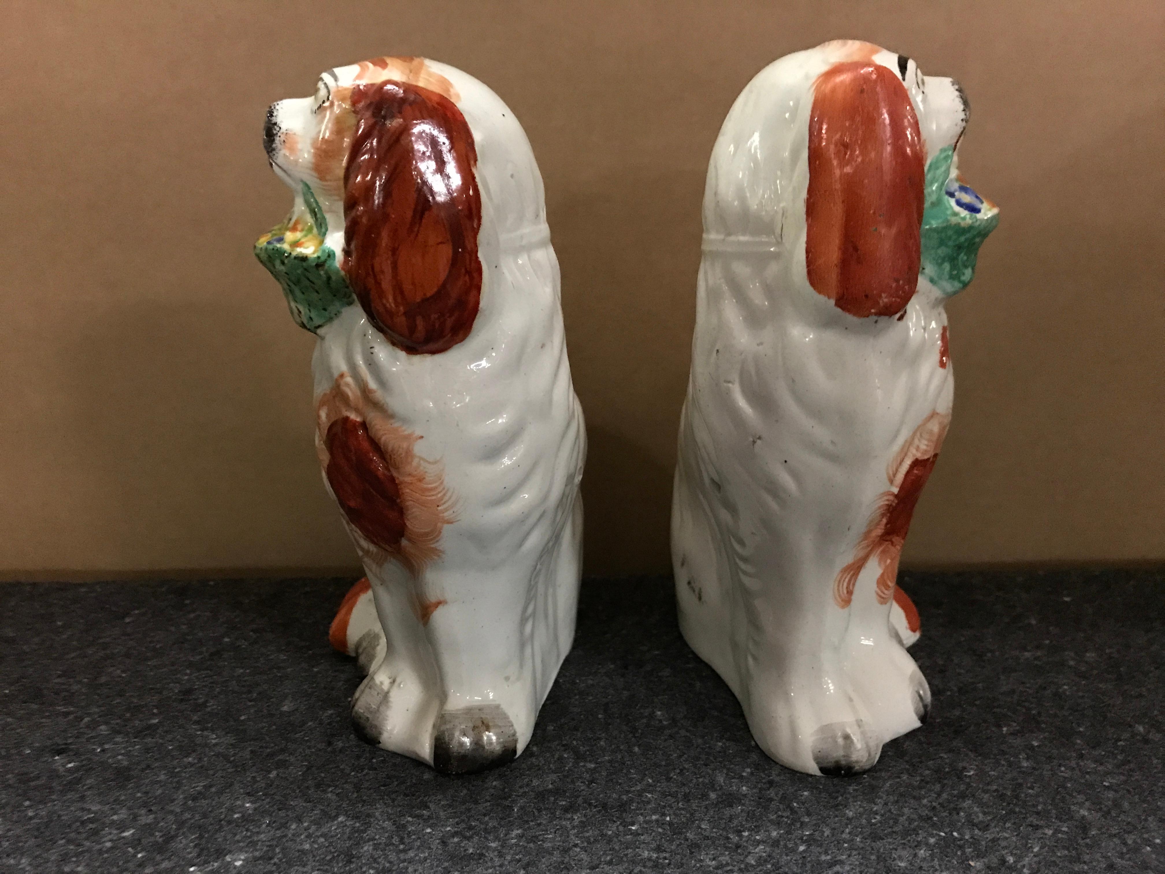 English Rare Pair of Staffordshire Seated Red Spaniels with Baskets of Flowers For Sale