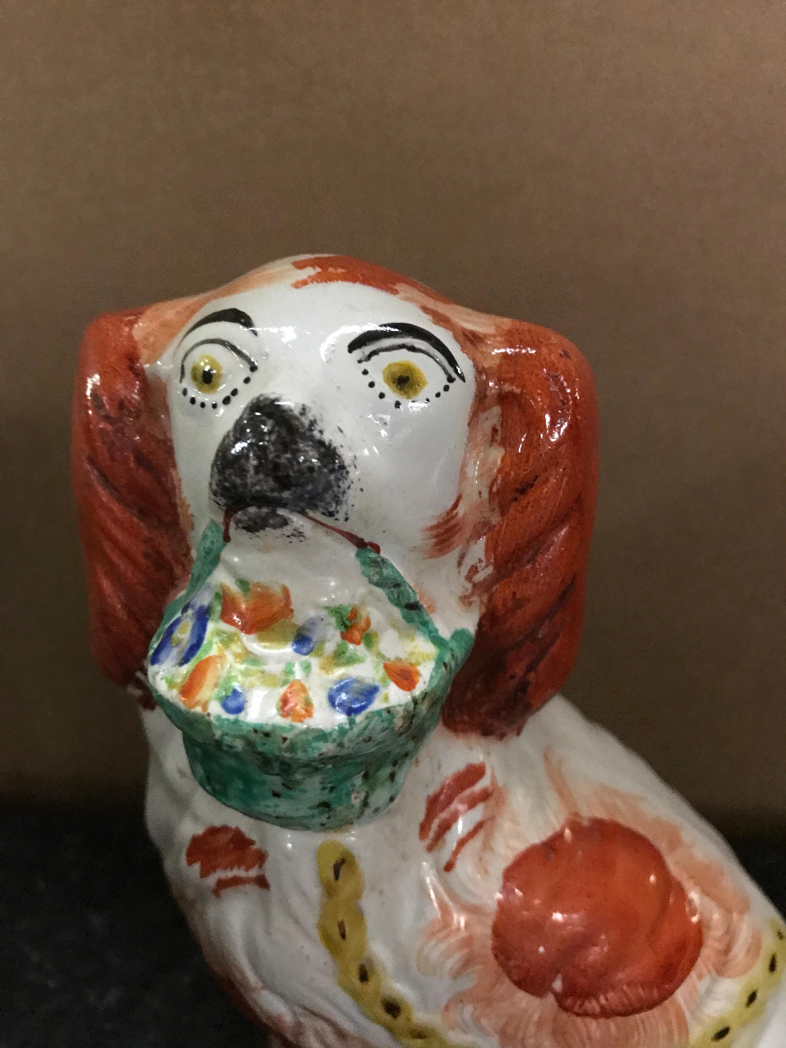 Pottery Rare Pair of Staffordshire Seated Red Spaniels with Baskets of Flowers For Sale