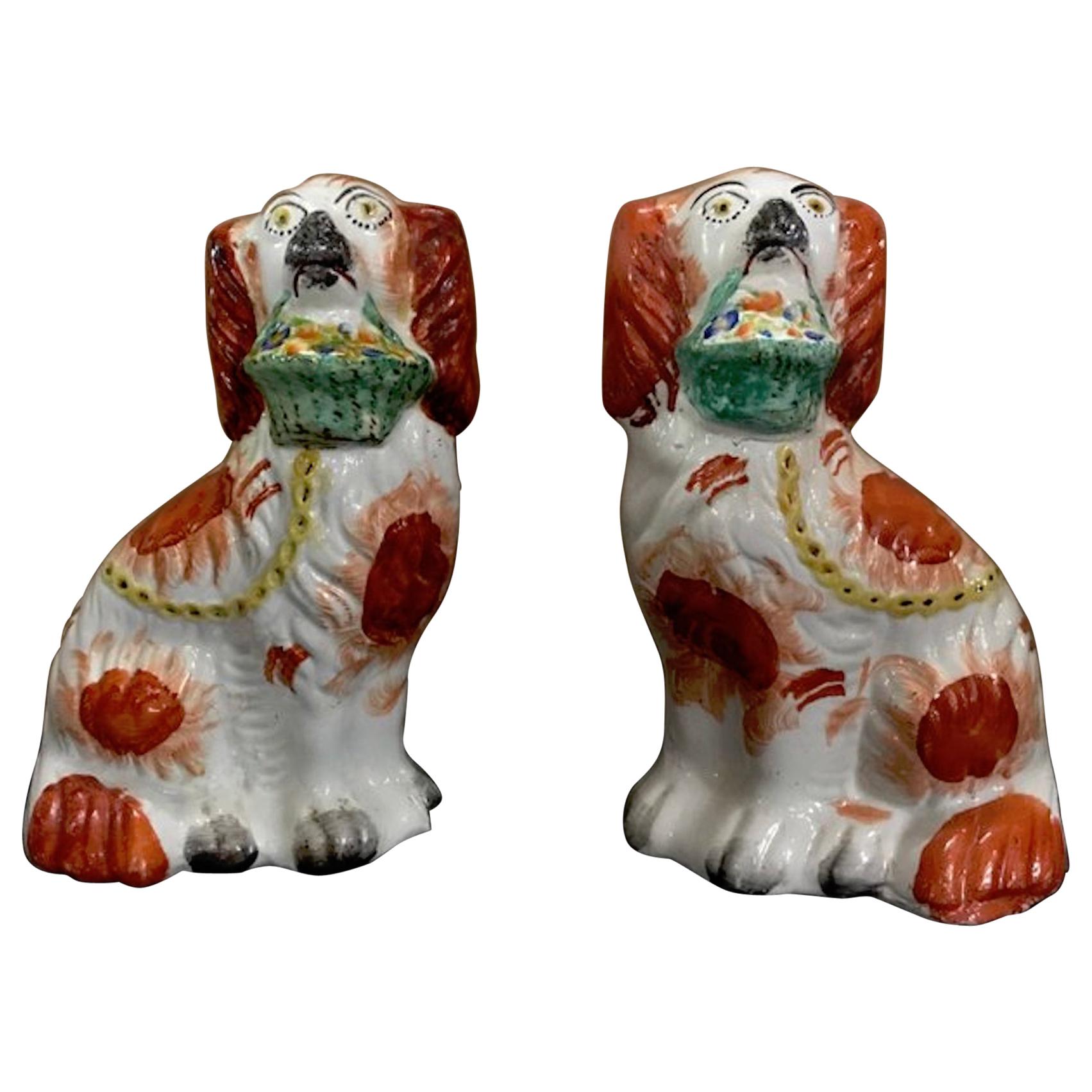 Rare Pair of Staffordshire Seated Red Spaniels with Baskets of Flowers For Sale