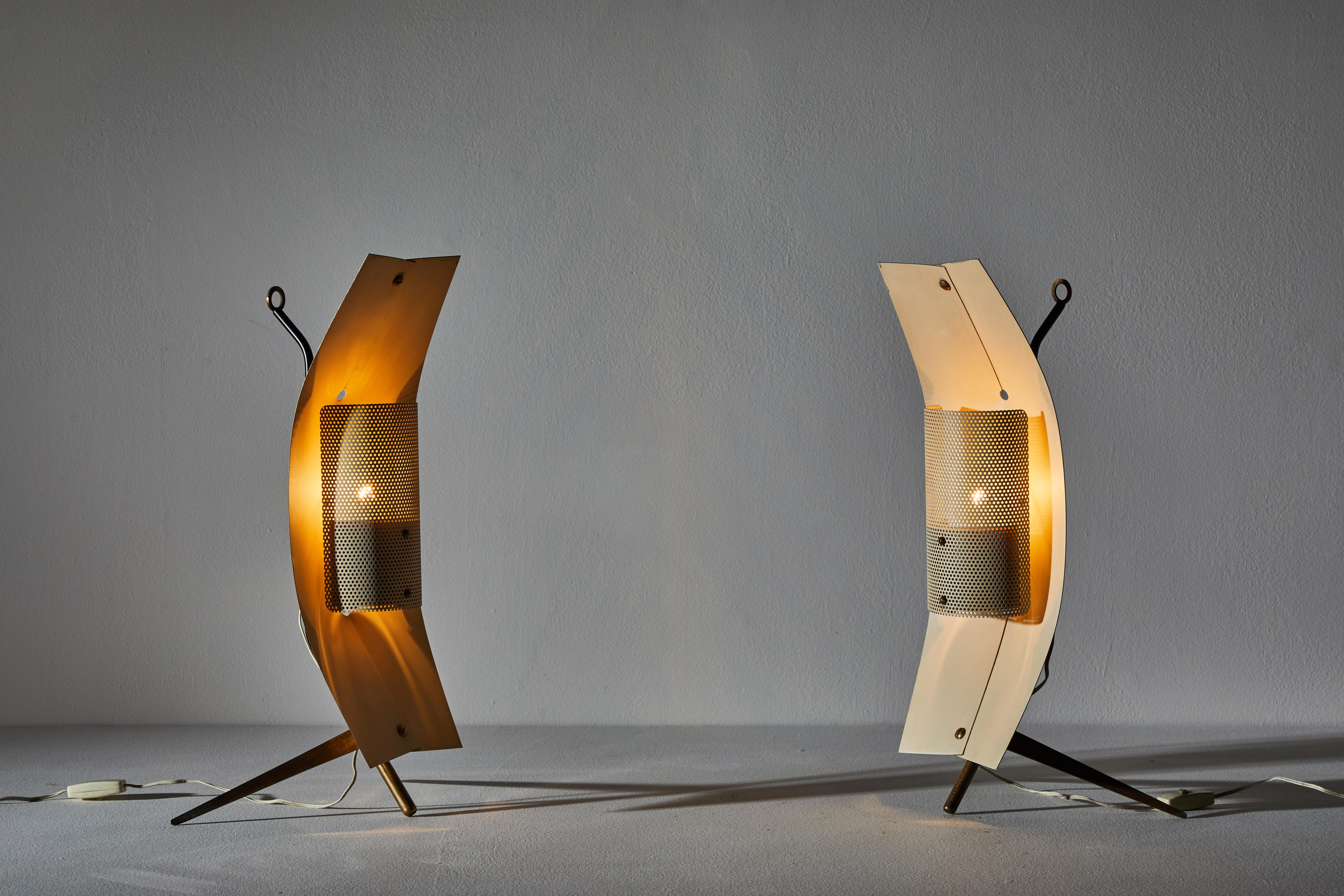 Rare pair of table/wall lights by Gastone Colliva. Designed and manufactured in Italy, circa 1960s. Perforated enameled metal, brass. Original cords. Can be used as a table lamp or wall light. We recommend one E27 75w maximum bulb per light. Bulbs