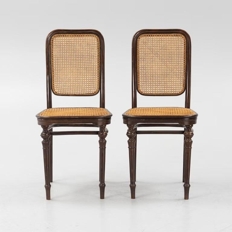 This rare pair of Thonet rattan chairs, crafted in 1890, showcases exceptional craftsmanship and timeless design. Produced by the renowned Thonet company, these chairs feature a sturdy rattan frame with intricate woven detailing that adds both