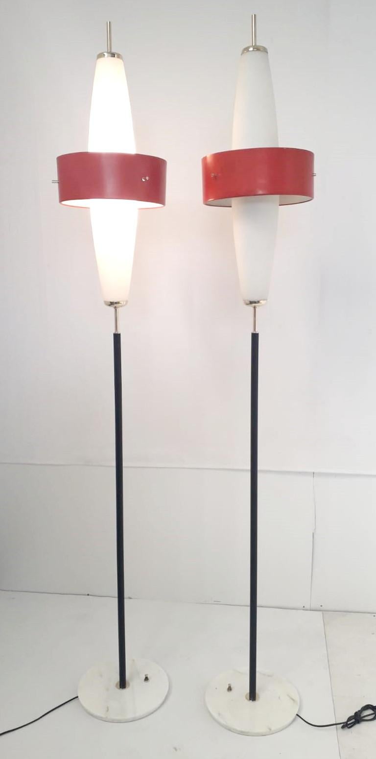 Rare pair of vintage Italian torchère floor lamps with frosted glass shades and red enameled metal bands, mounted on marble base / Designed by Stilnovo circa 1950s / Made in Italy
Measures: Height: 80 inches / diameter: 12 inches
1 pair in stock in