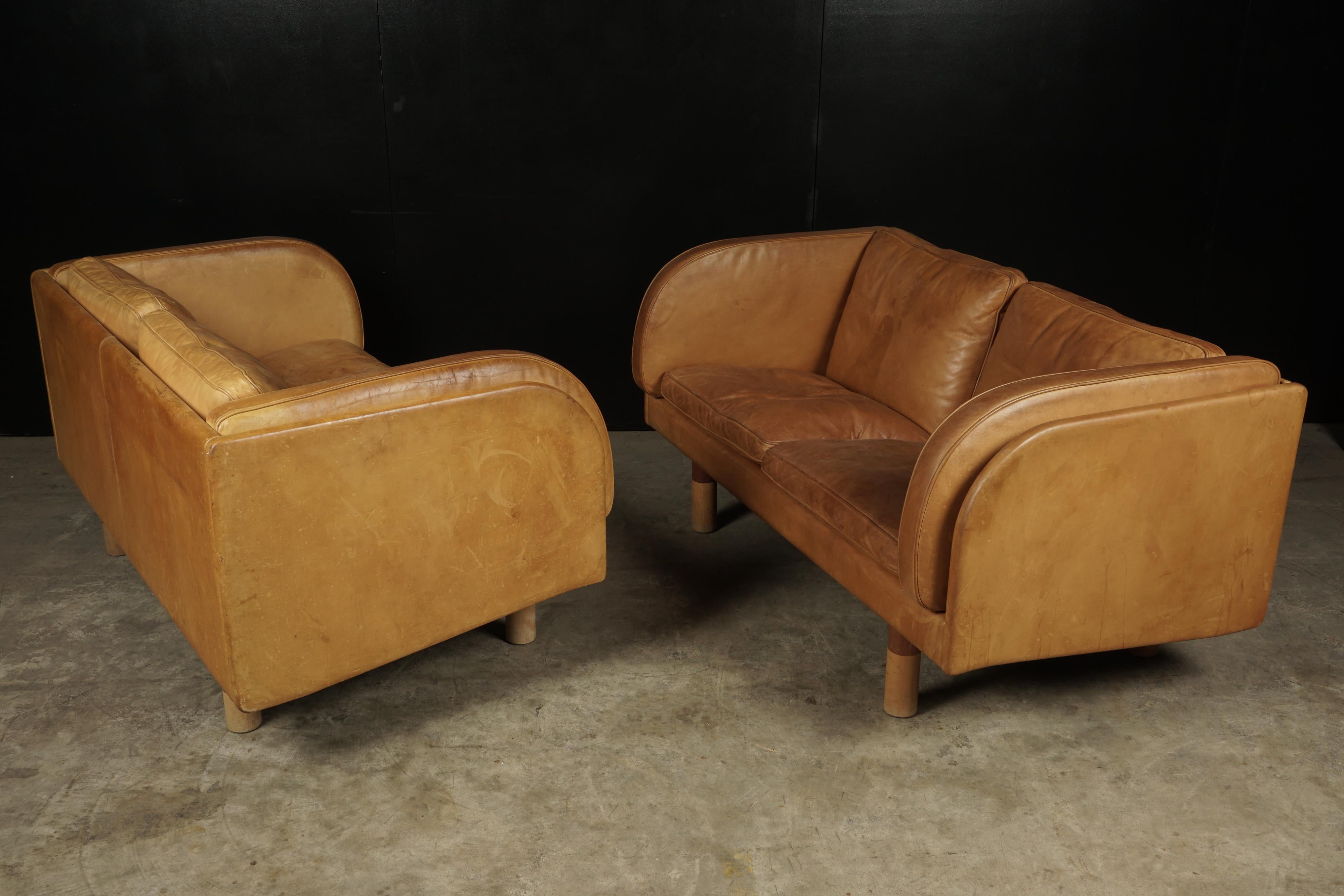 Rare pair of two seat sofas in cognac leather designed by Jørgen Gammelgaard, circa 1980. Superb quality and patina.