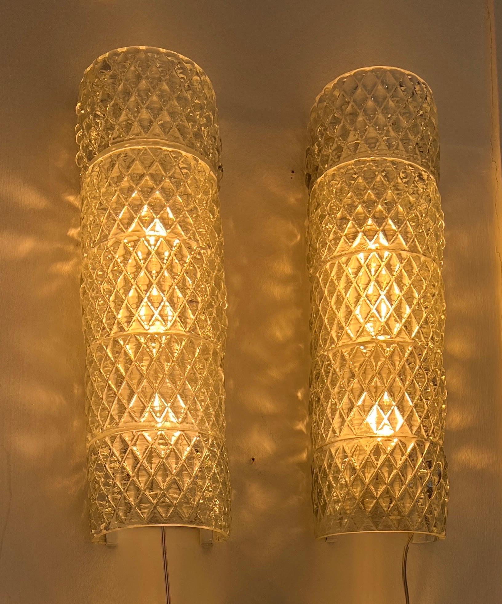 A rare pair of Venini glass wall sconces consisting of five semicircular blown glass each produced around the 1940s . The glass is exhibited at the Museo del vetro di Murano. 
We have an additional pair of four tiers each that you could install
