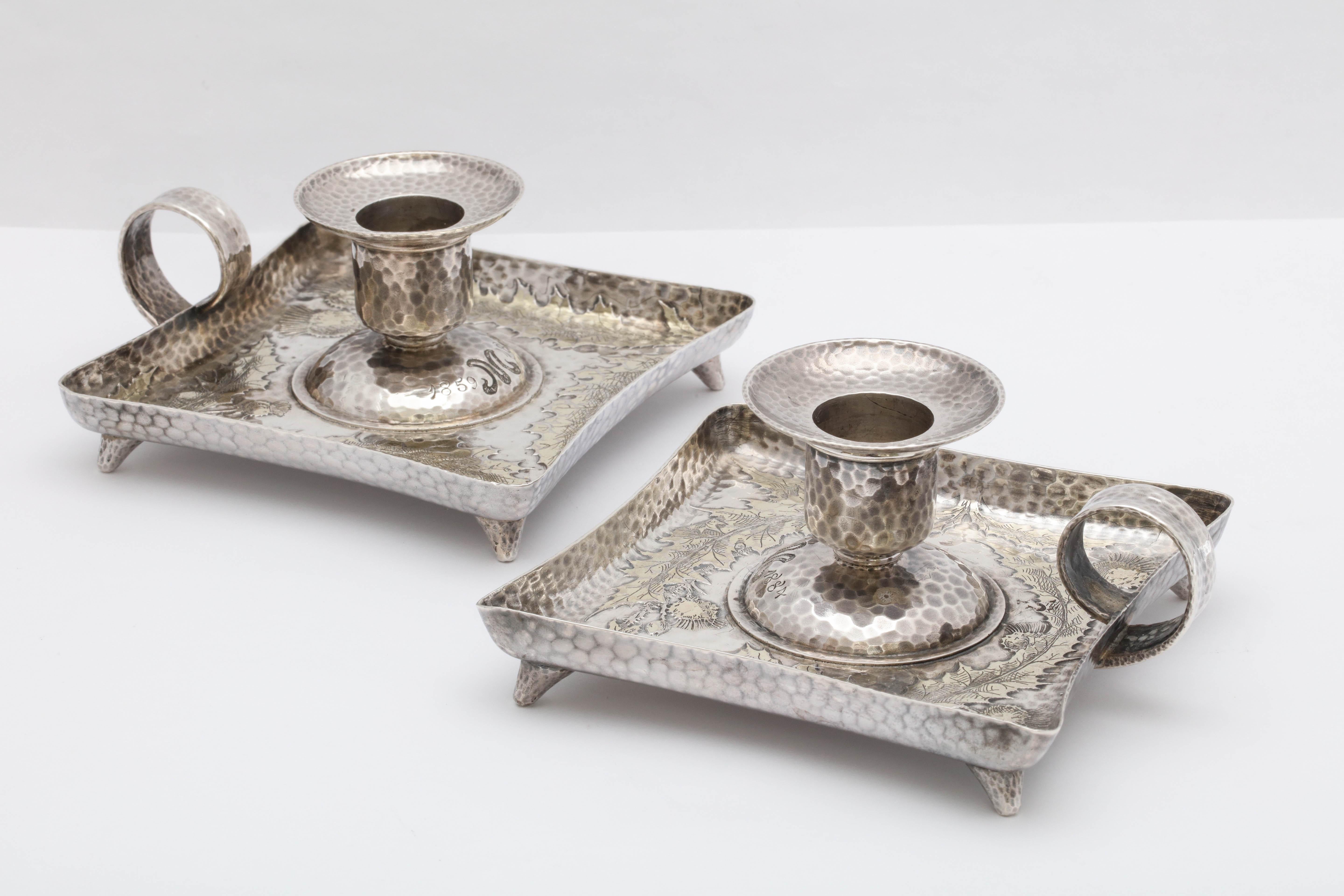 Rare pair of Victorian, parcel-Gilt, footed, sterling silver, square based chamber candlesticks by Tiffany and Company, New York, inventory marked for the year 1882. Silver is hammered in design and has gilded thistles. Removable bobeches. Each is