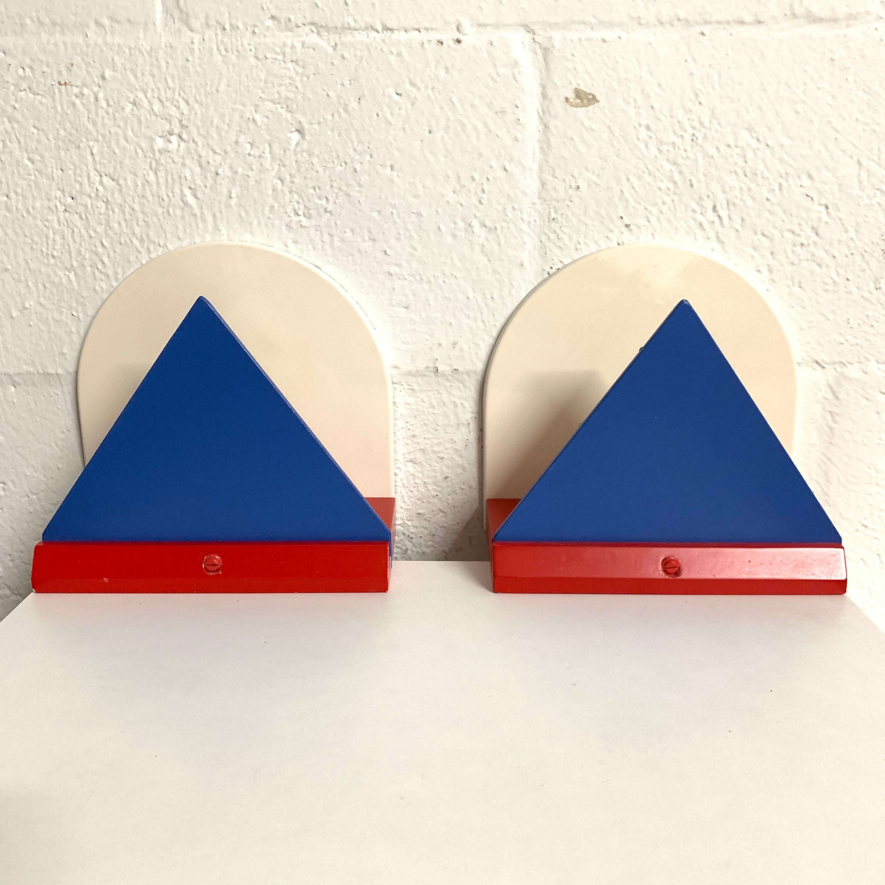 Pair of geometric postmodern wall lights lamps or sconces rendered in metal wood and plastic in red white and blue primary colors, by Ikea, 1980s.