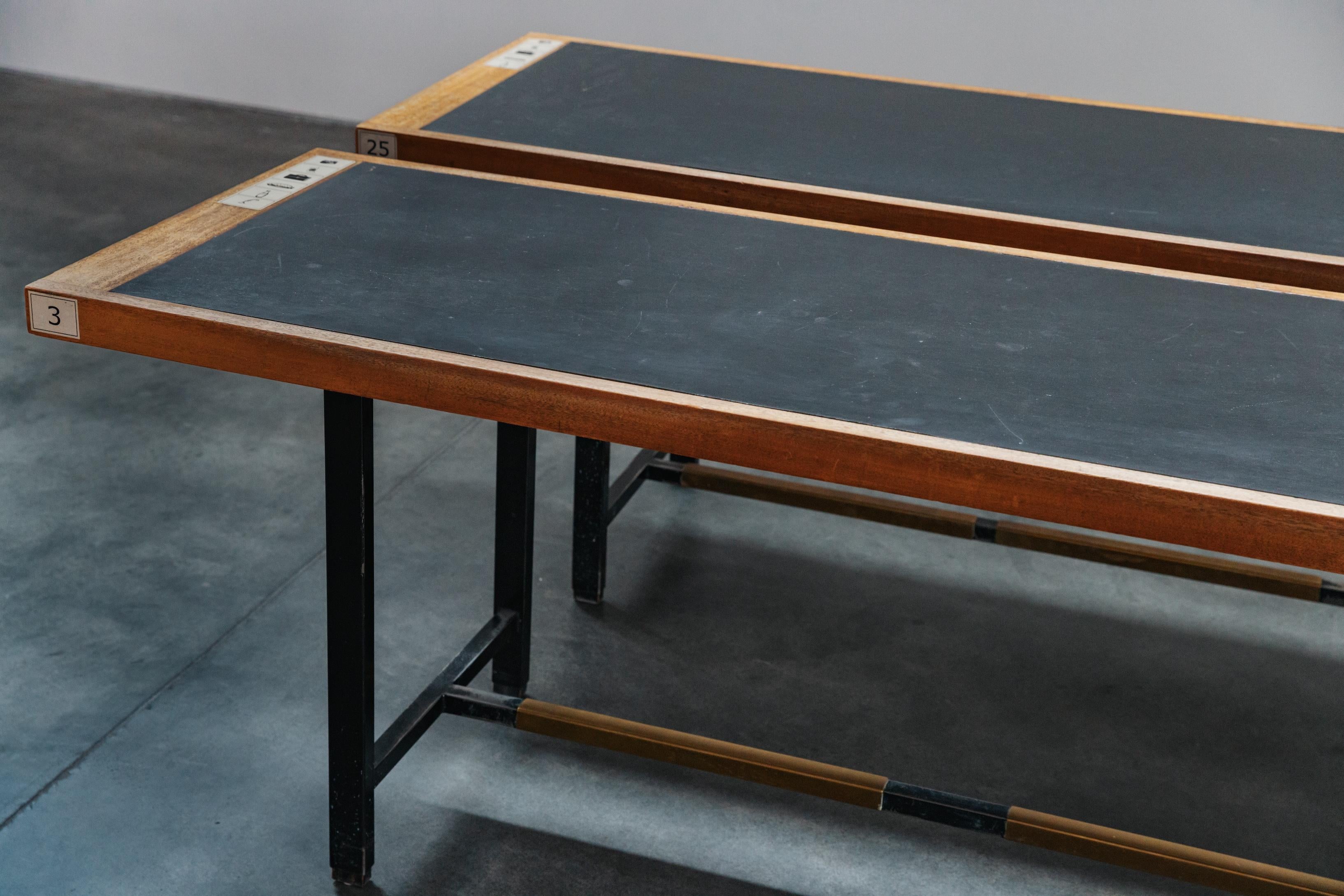 Rare Pair of Vintage University Tables From France, Circa 1970.  Steel and brass base with great patina.  Leather top with original cafeteria stickers.  
