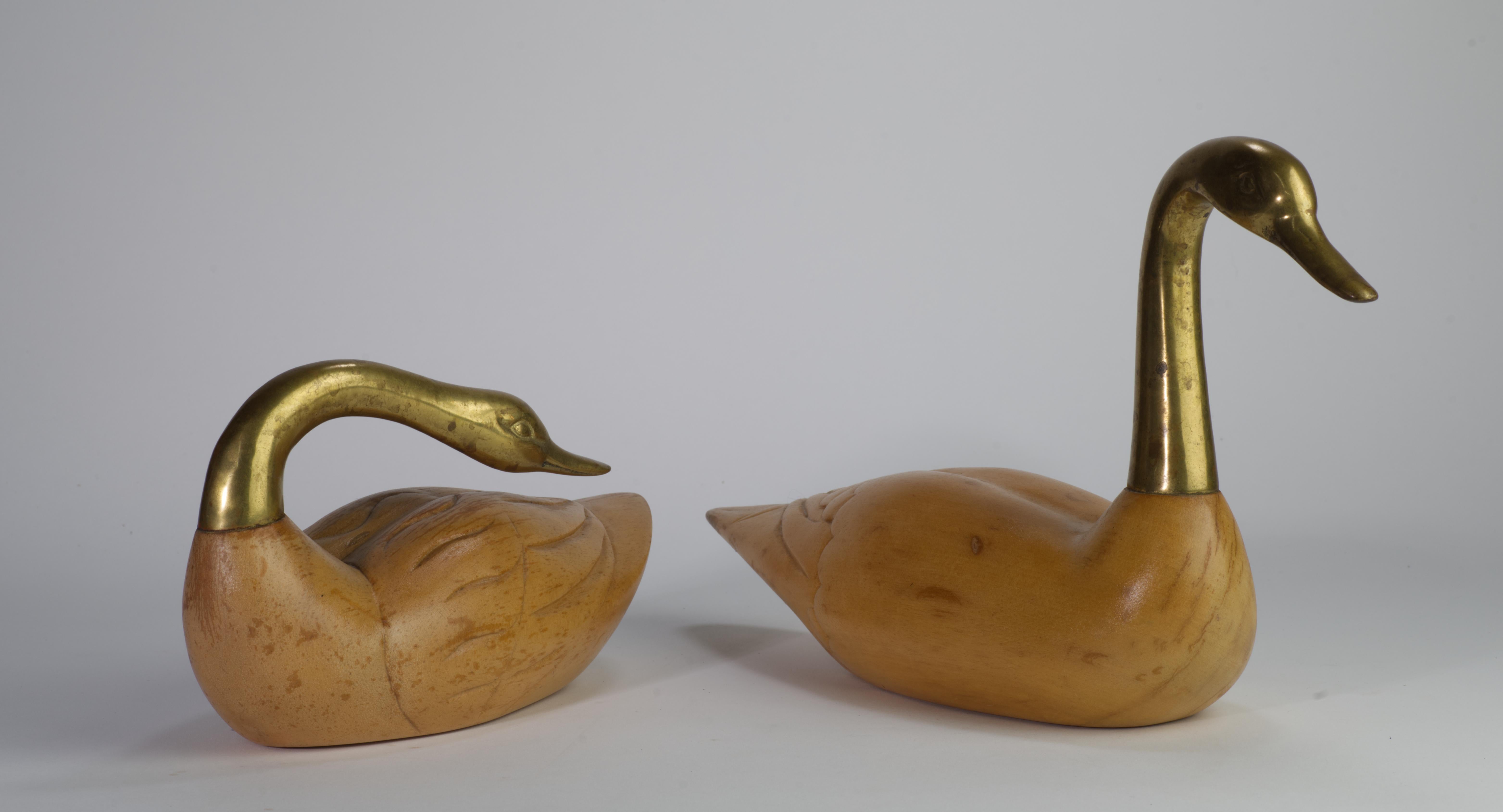 Vintage pair of crane figurines from Wildwood Imports has detailed carved wooden bodies and sculptural bronze heads and necks.

The swans are signed on the bottoms with 2 original stickers, 