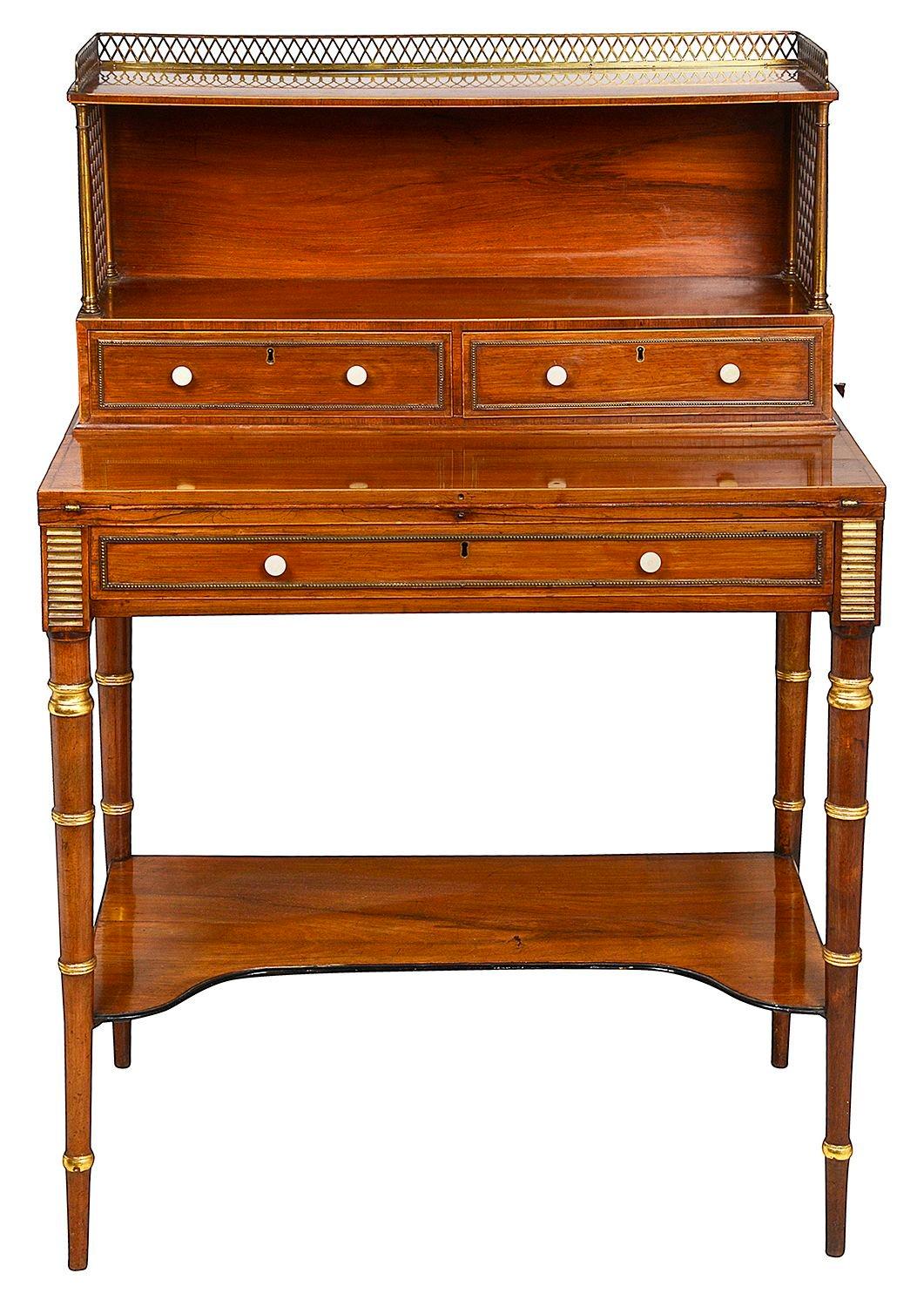 A fine quality and rare pair of Regency period Rosewood Bon huer du Jours. Each with three quarter brass gallery to the top, trellis panels and drawers to the super structure. Hinged writing tablets opening to reveal inset tooled leather, frieze