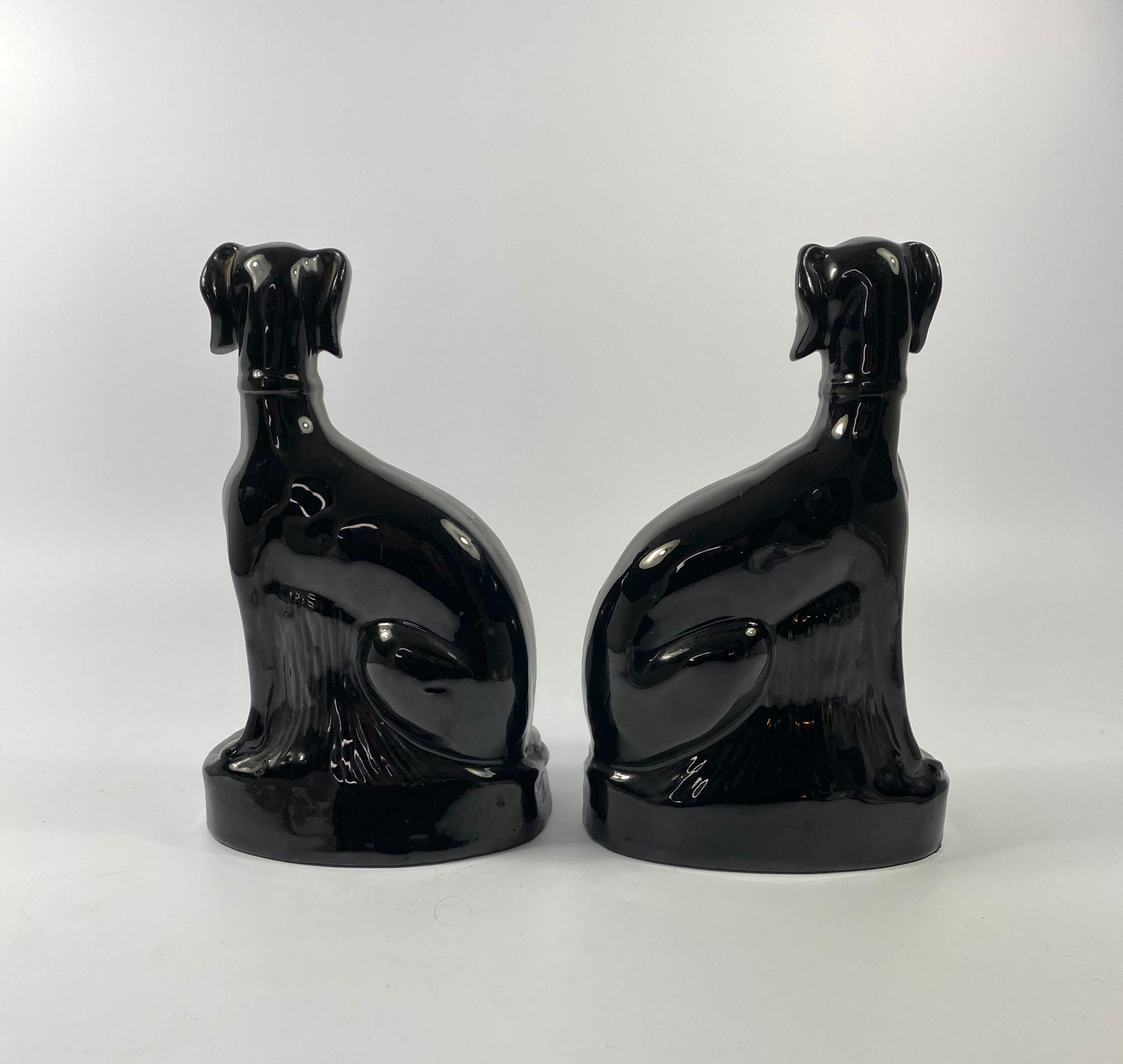 Rare pair of Staffordshire ‘Jackfield’ pottery Lurchers, c. 1860. The finely modelled dogs, having separate front legs, and covered in a black glaze. Painted with blue eyes, and edged in gilt.

See – ‘A-Z of Staffordshire Dogs’, Clive Mason Pope,