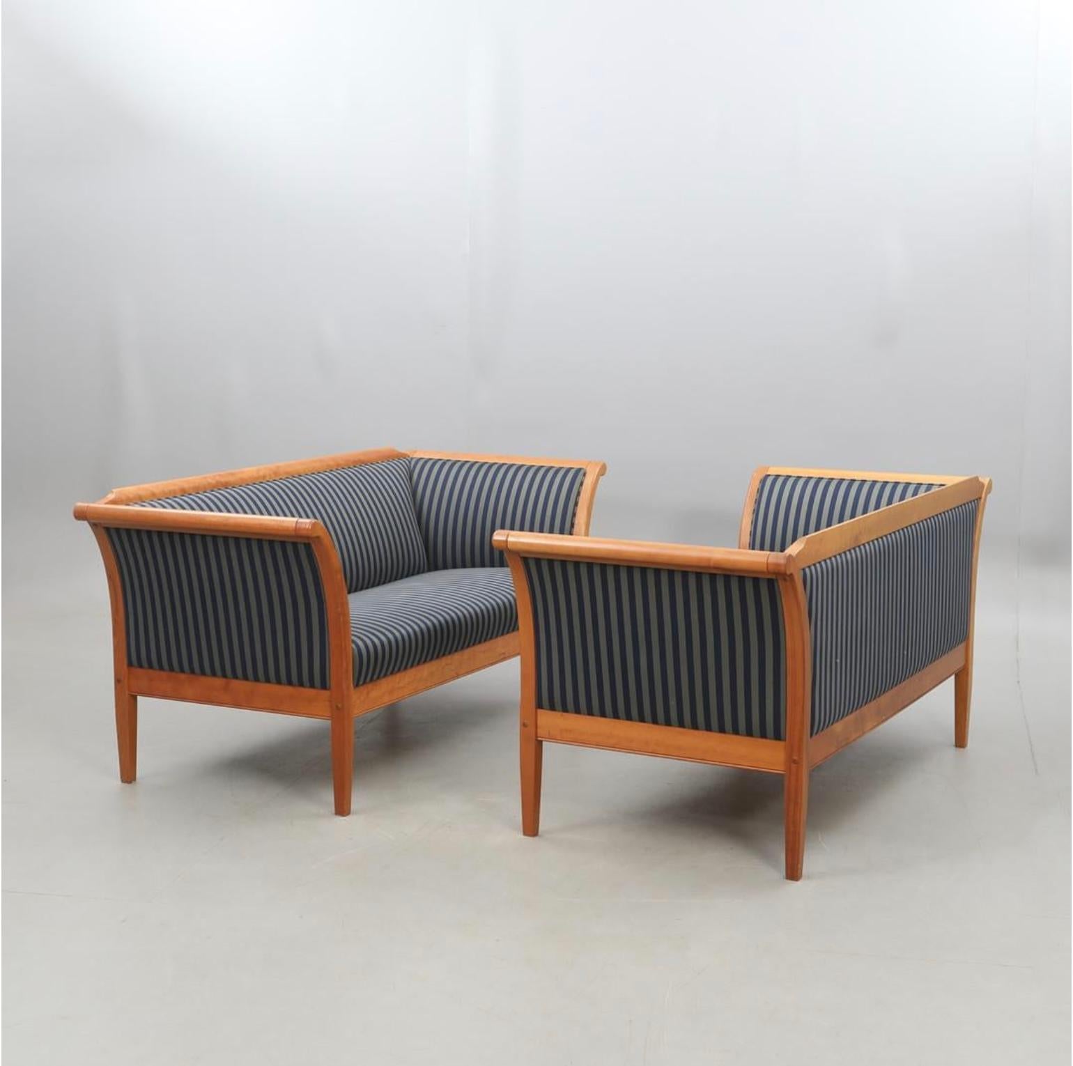 Rare pair of  Swedish Biedermeier Empire style sofas from latter part of 20th Century in top grade birch in a light  oak French polish finish. 

Its very unusual indeed to find a matching pair of sofas in this style and in this condition.

Each sofa