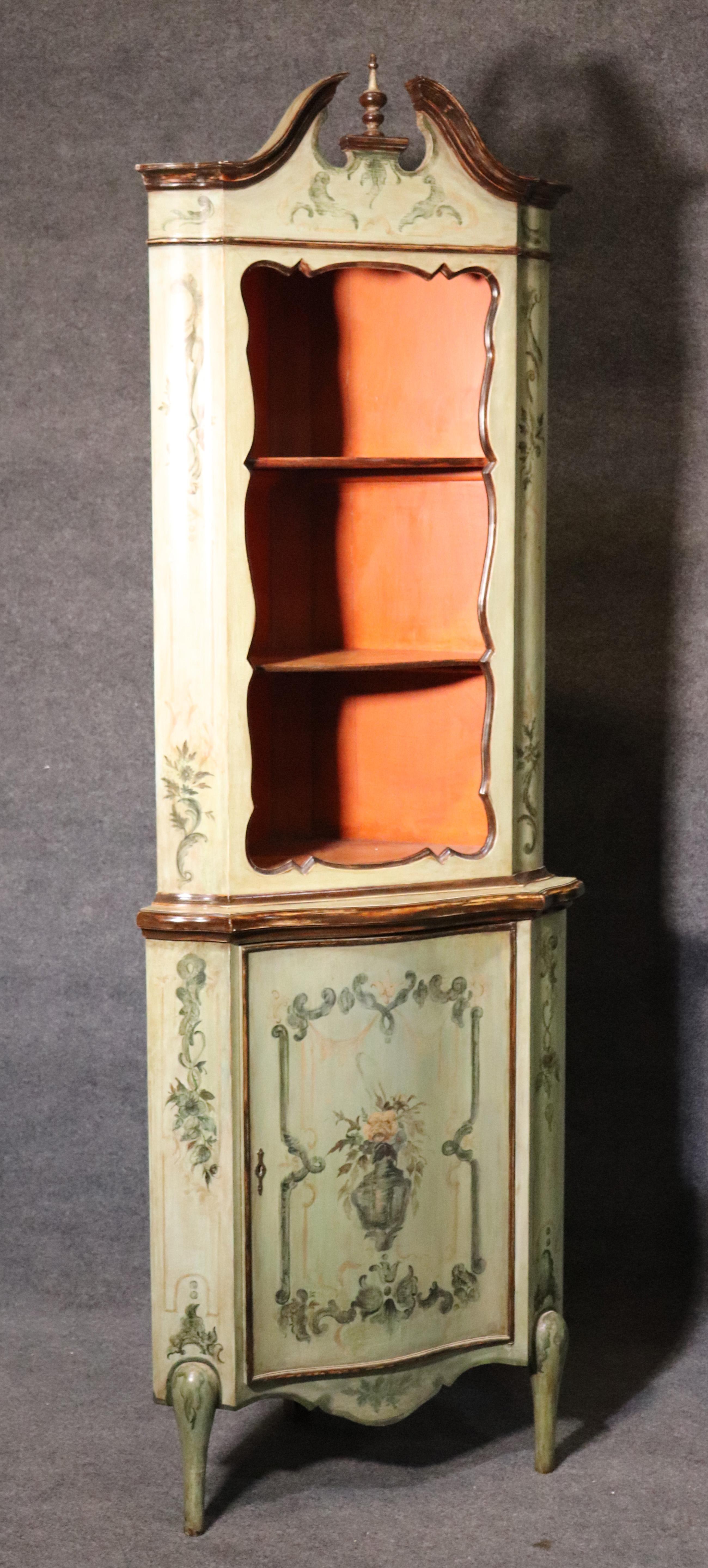 These are hard to find and especially in good condition and in pairs. This pair of hand painted antique Venetian corner cabinets have a wonderful soft grayish green hue with shades of blue and other soft colors with a persimmon interior. The