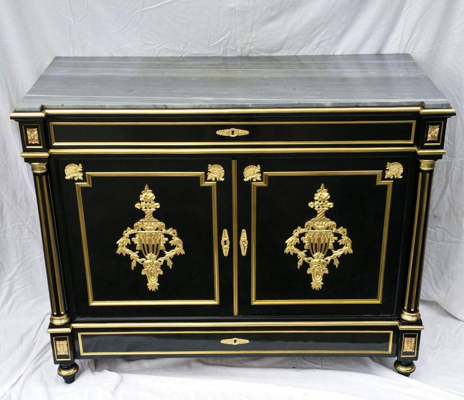 Rare pantalonnière cabinet, with several drawers for pants trousers in blackened fruitwood with Brass inlay in Boulle style and gilt bronze ornamentations, a light grey marble top and detached fluted columns. 

A real bedroom closet a real unique